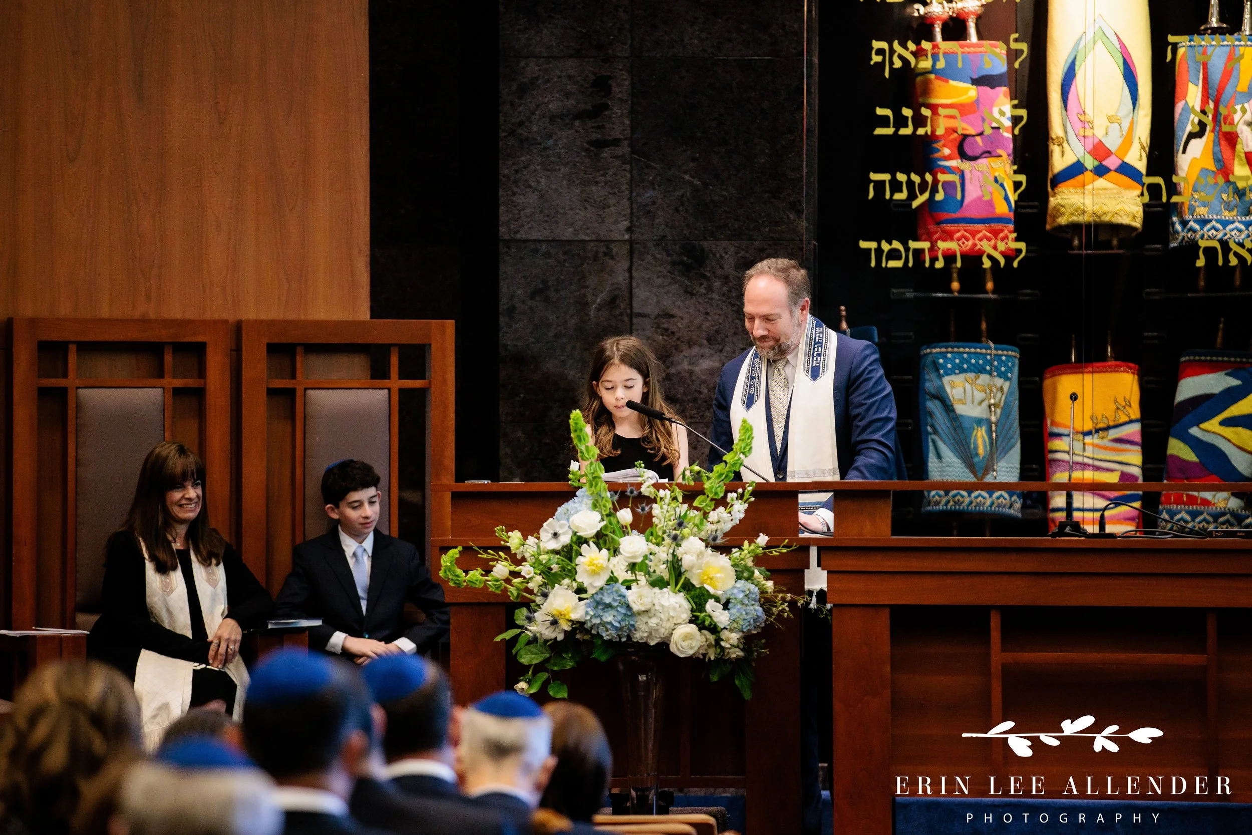 Sibling reading prayer during mitzvah service at The Temple Nashville