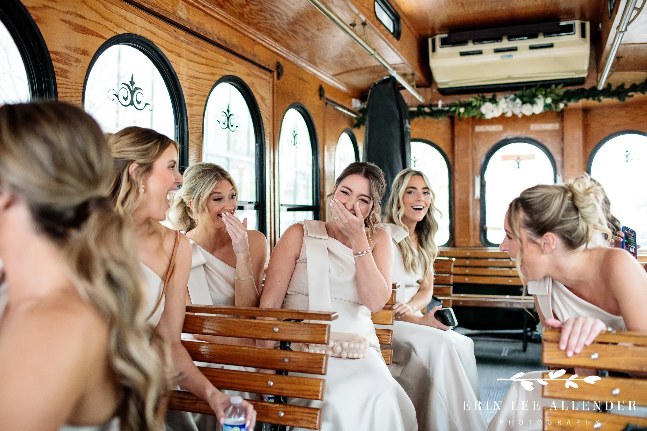 Nashville wedding photography — bridal party laughing on the trolley ride to the ceremony through downtown Nashville
