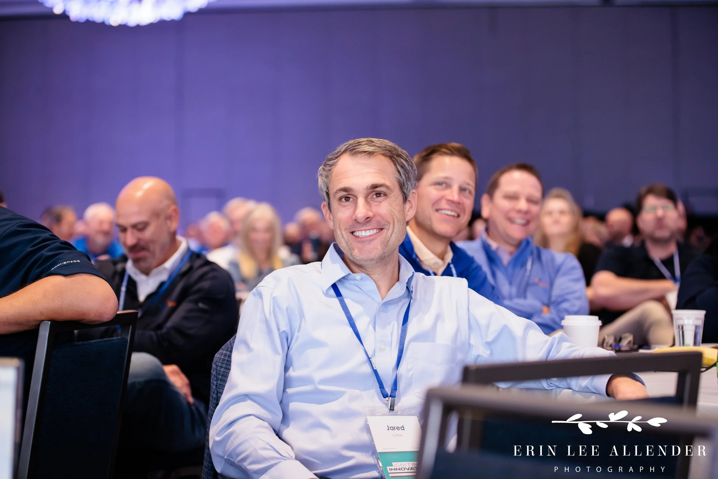 Nashville corporate event photographer capturing attendees laughing at a keynote speaker's joke during RubinBrown's conference at Gaylord Opryland Resort