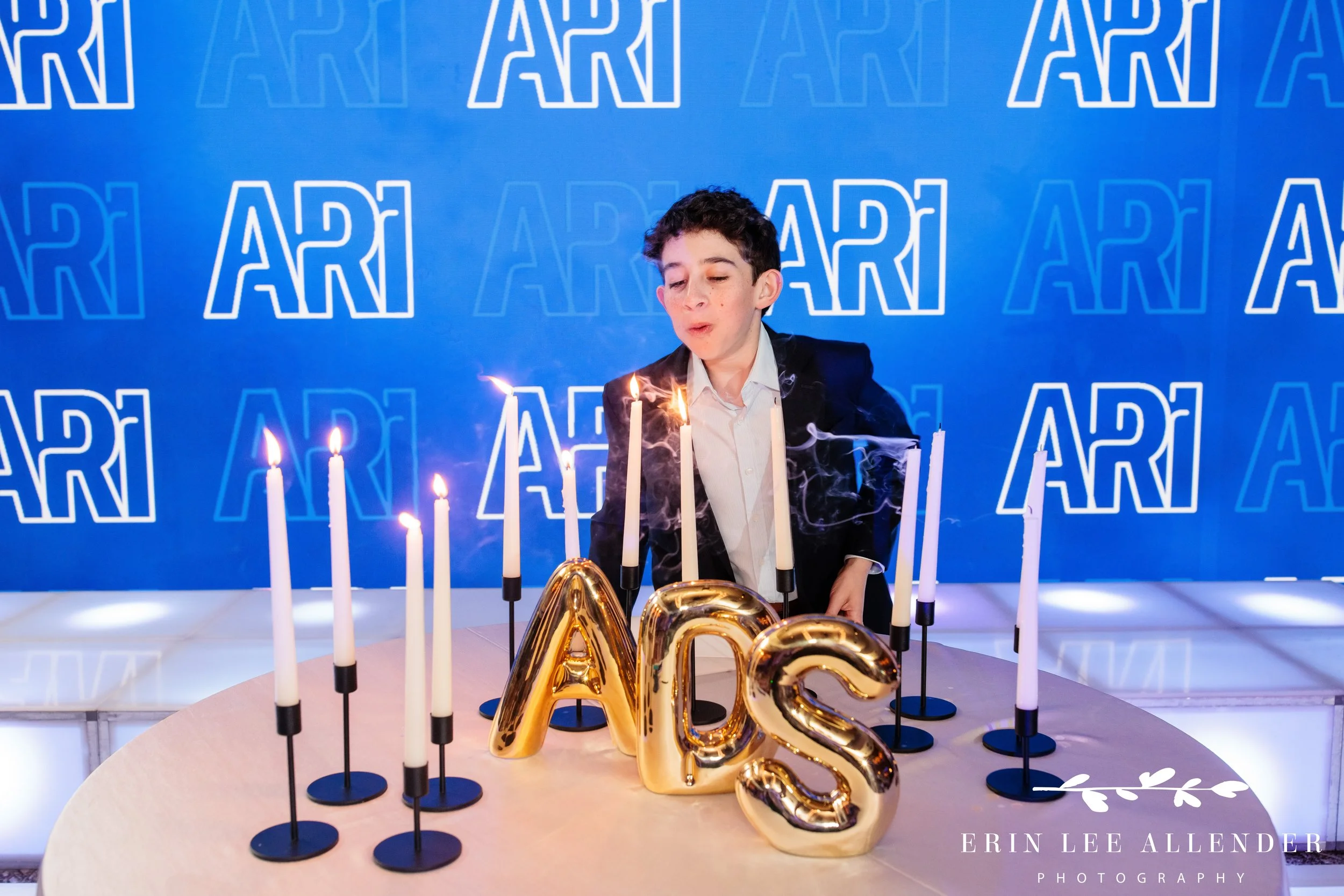 Bar Mitzvah blowing out candles at the end of candle lighting ceremony nashville w hotel.