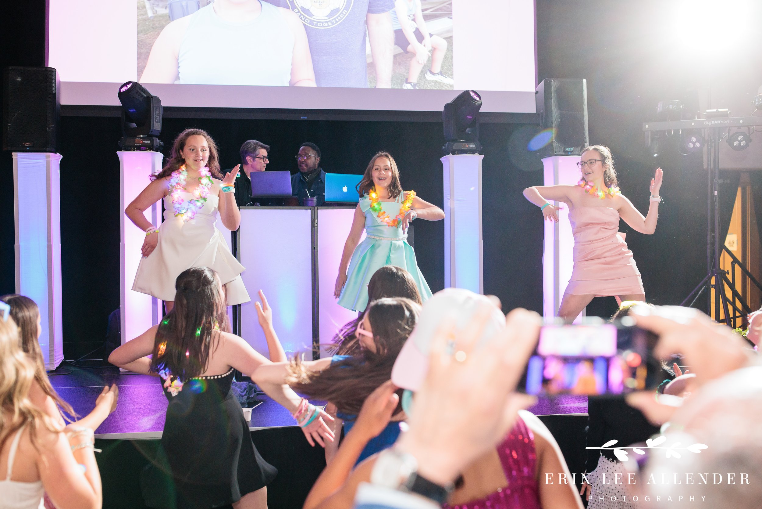 Nashville mitzvah photography — girls dancing on stage at Sari's Beach Bash at the Loveless Barn