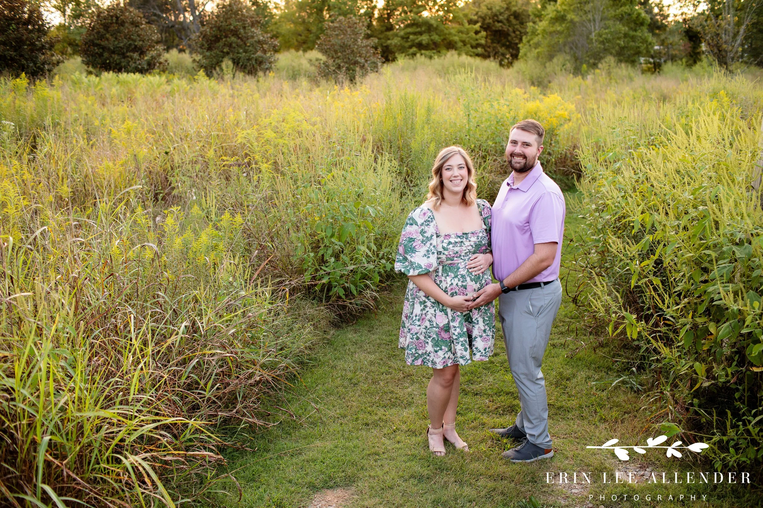 Husband and wife embracing during outdoor maternity session at Long Hollow Gardens in Gallatin, Tennessee