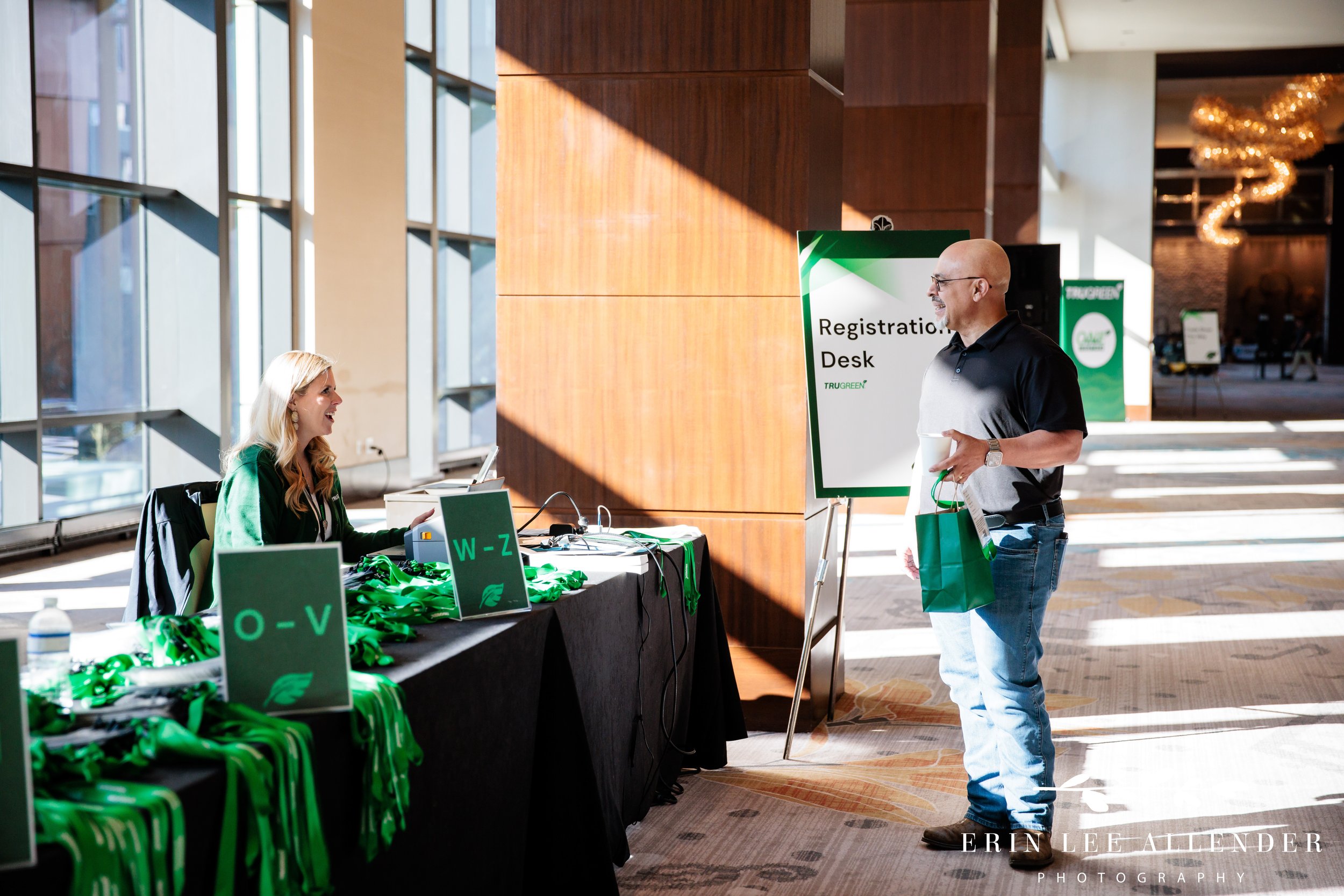 Nashville corporate event photographer — TruGreen Leadership Summit attendee speaking with registration staff at Omni Nashville