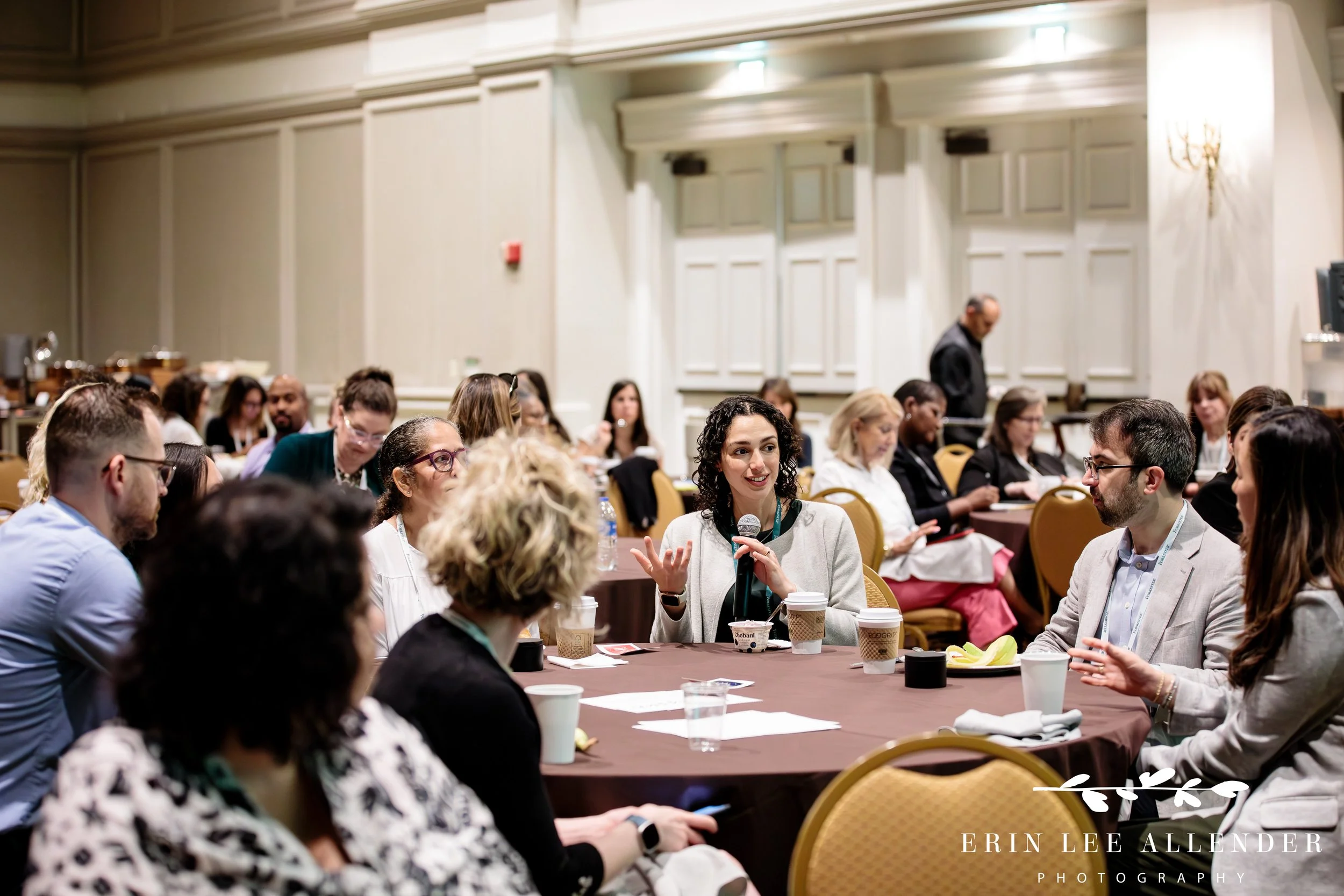 Nashville event photography — conference attendees engaged in conversation at tables during a Forrester CX Conference breakout session at Gaylord Opryland Hotel