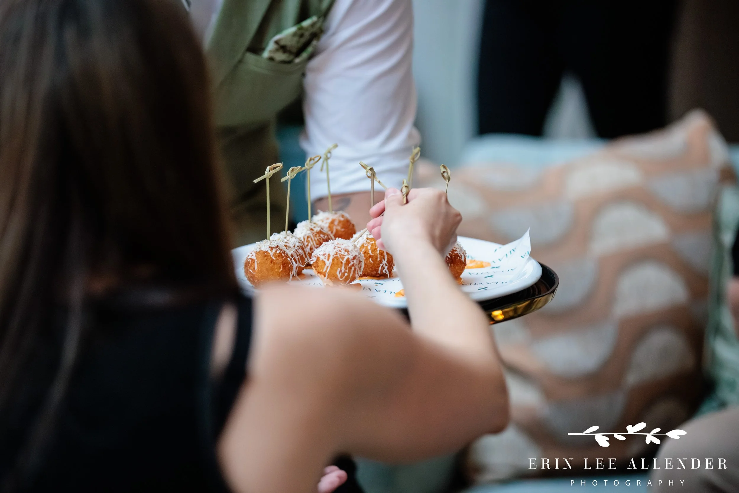 Guest picking up an Alla Vita risotto ball from a passed tray at a Middleman Nashville networking reception