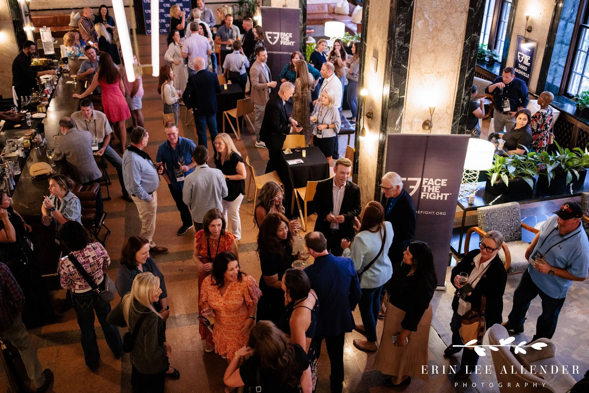 Nashville corporate event photographer — overhead view of guests mingling at Face the Fight's cocktail party at Noelle