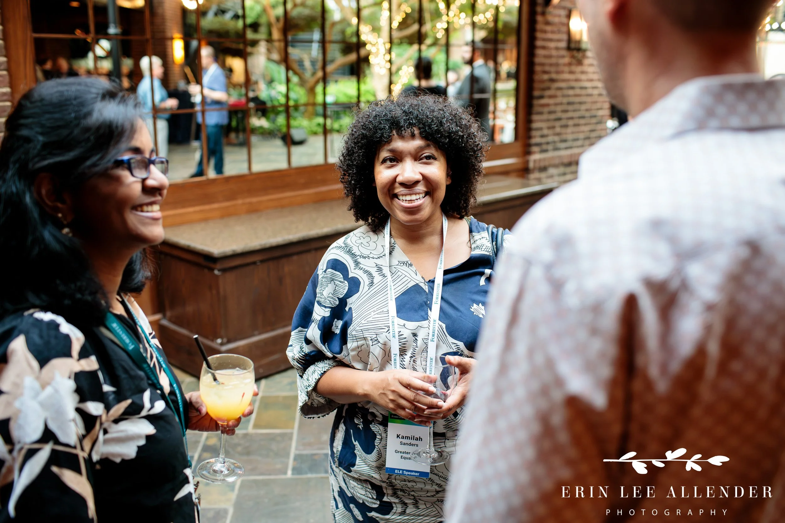 Group of attendees laughing during networking reception at Opryland Hotel