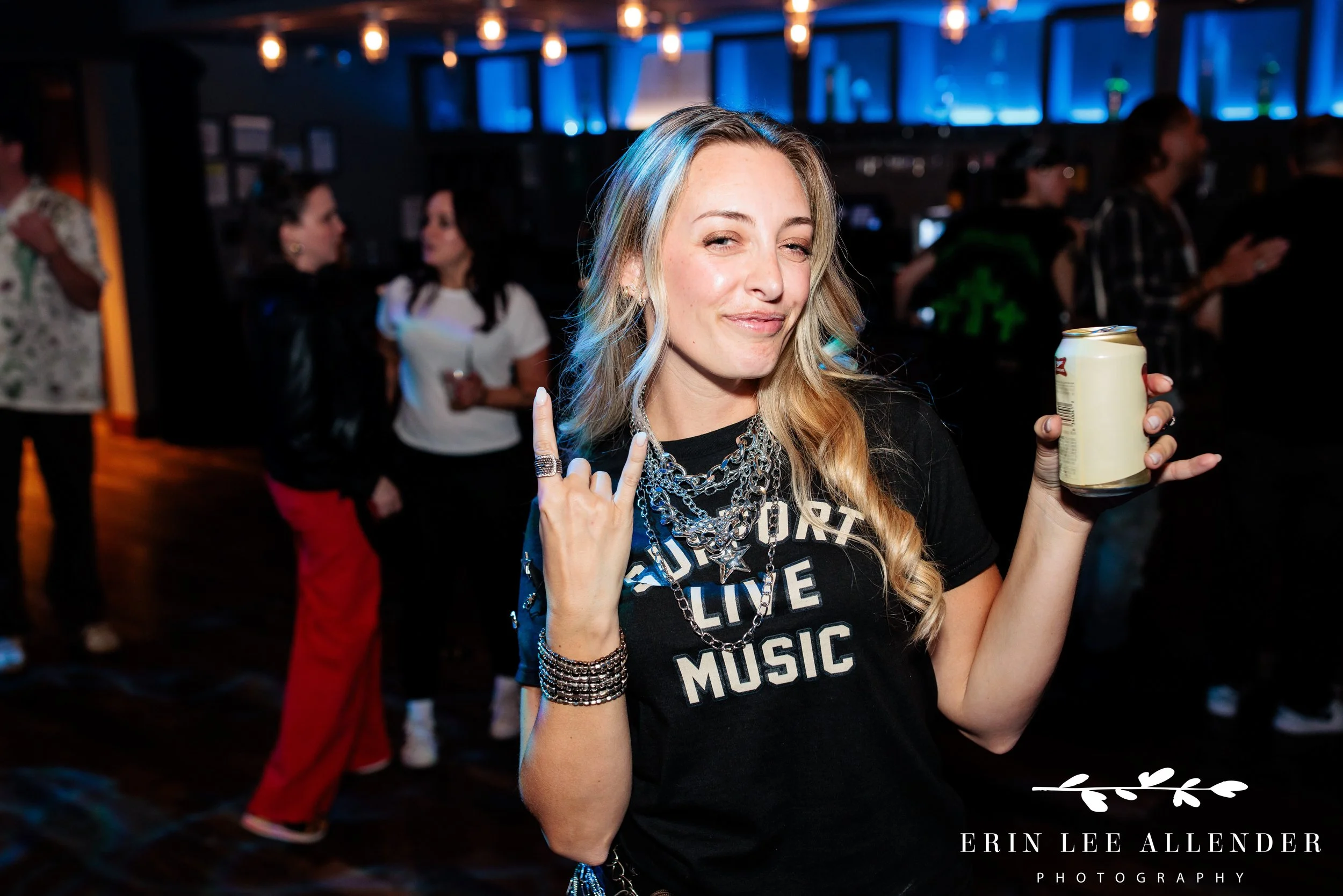 Nashville corporate event photography — ambassador holding beer and giving rock sign at rockstar-chic advocacy awards, Woolworth Theatre Nashville