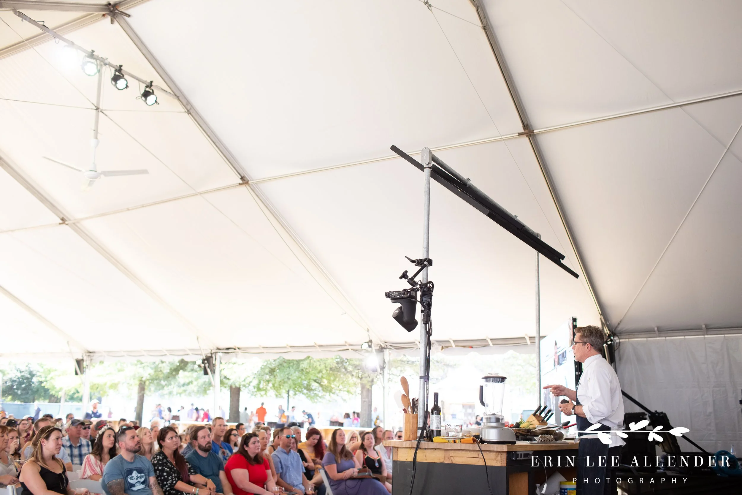 Wide shot of chef Rick Bayless presenting to the crowd at the Music City Food and Wine Festival Nashville Tennessee