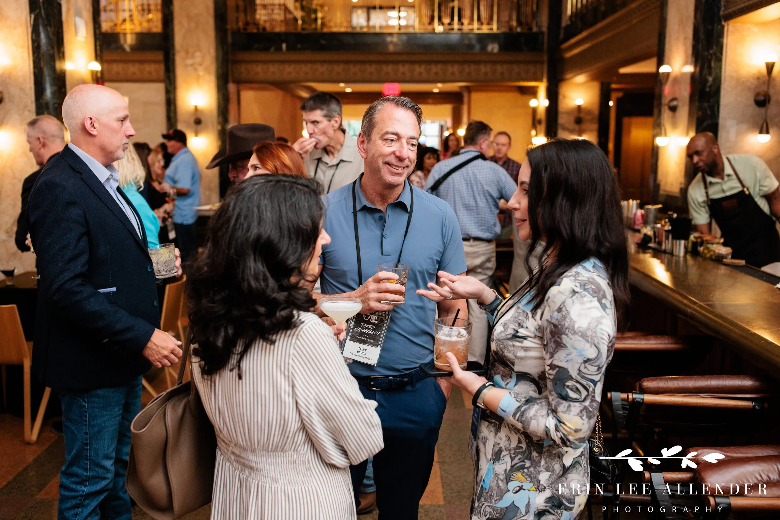 Nashville event photography — small group in conversation at Face the Fight Takes Nashville opening night at Noelle