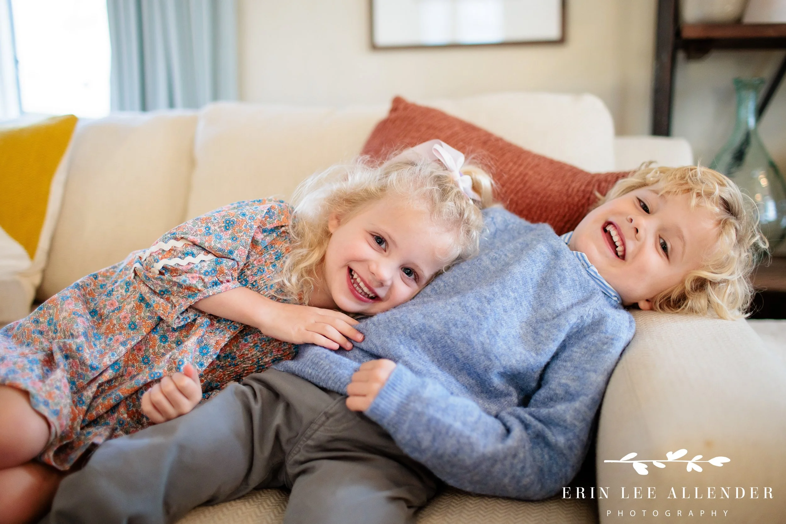 Nashville family photography — young siblings snuggled together on the couch during an in-home fall session