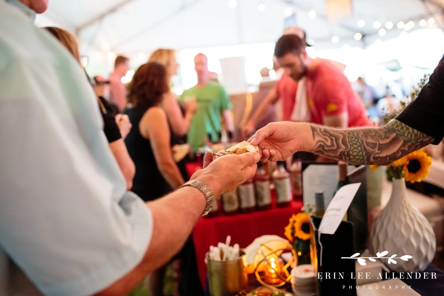 Close up of hands handing out and receiving food samples at the Music City Food and Wine Festival Nashville Tennessee