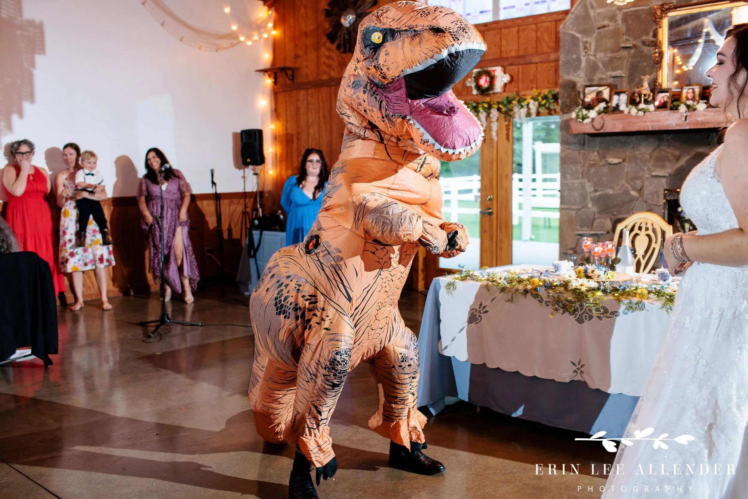 Groomsman in a T-rex costume opening the reception dance floor