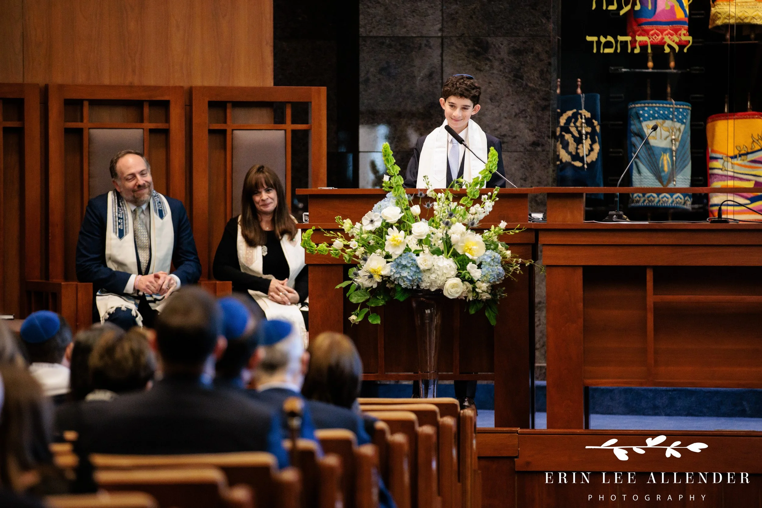 Bar mitzvah giving speech while smiling at friends and family at The Temple