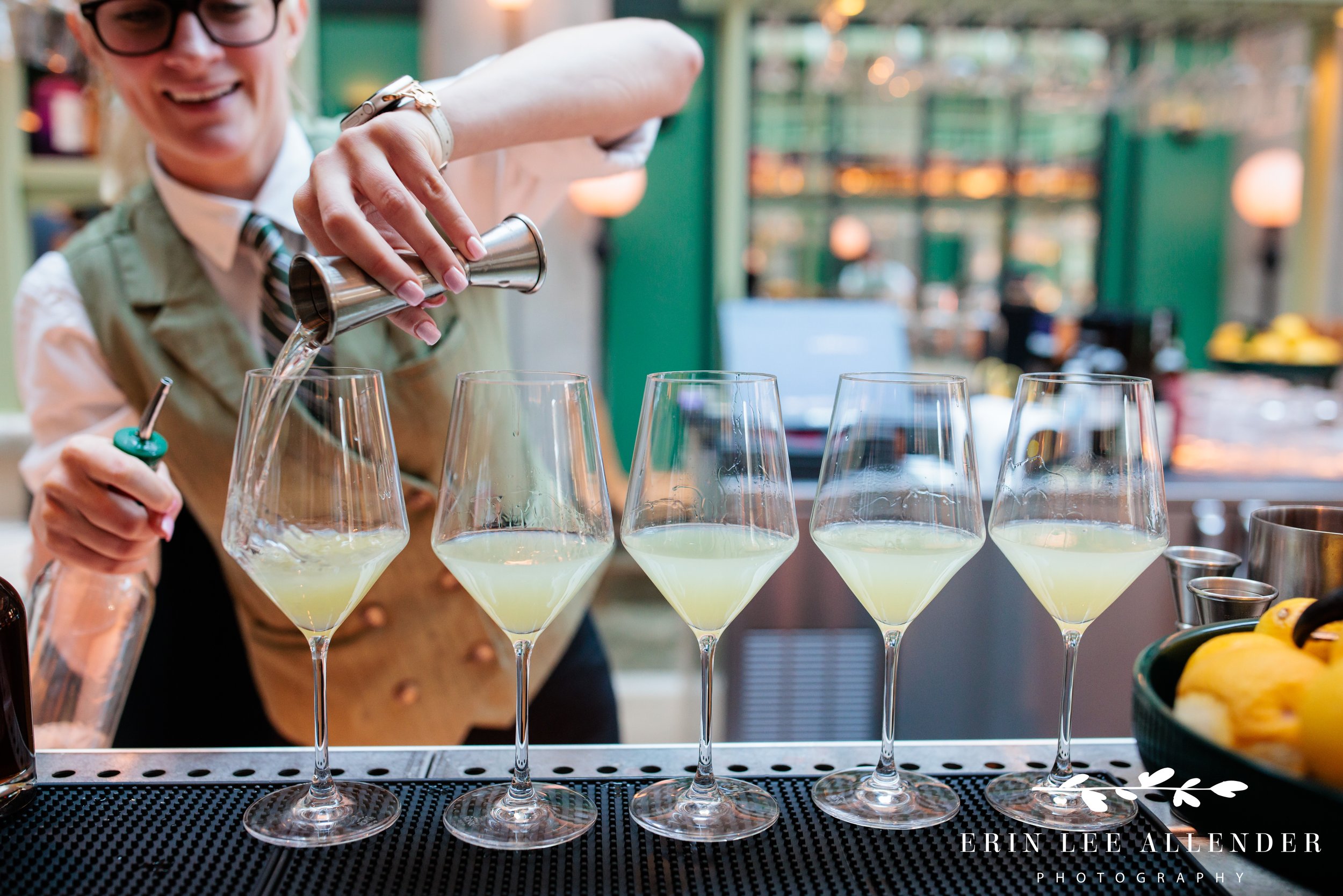 Middleman bartender pouring a row of cocktails in one line during a Nashville corporate event reception
