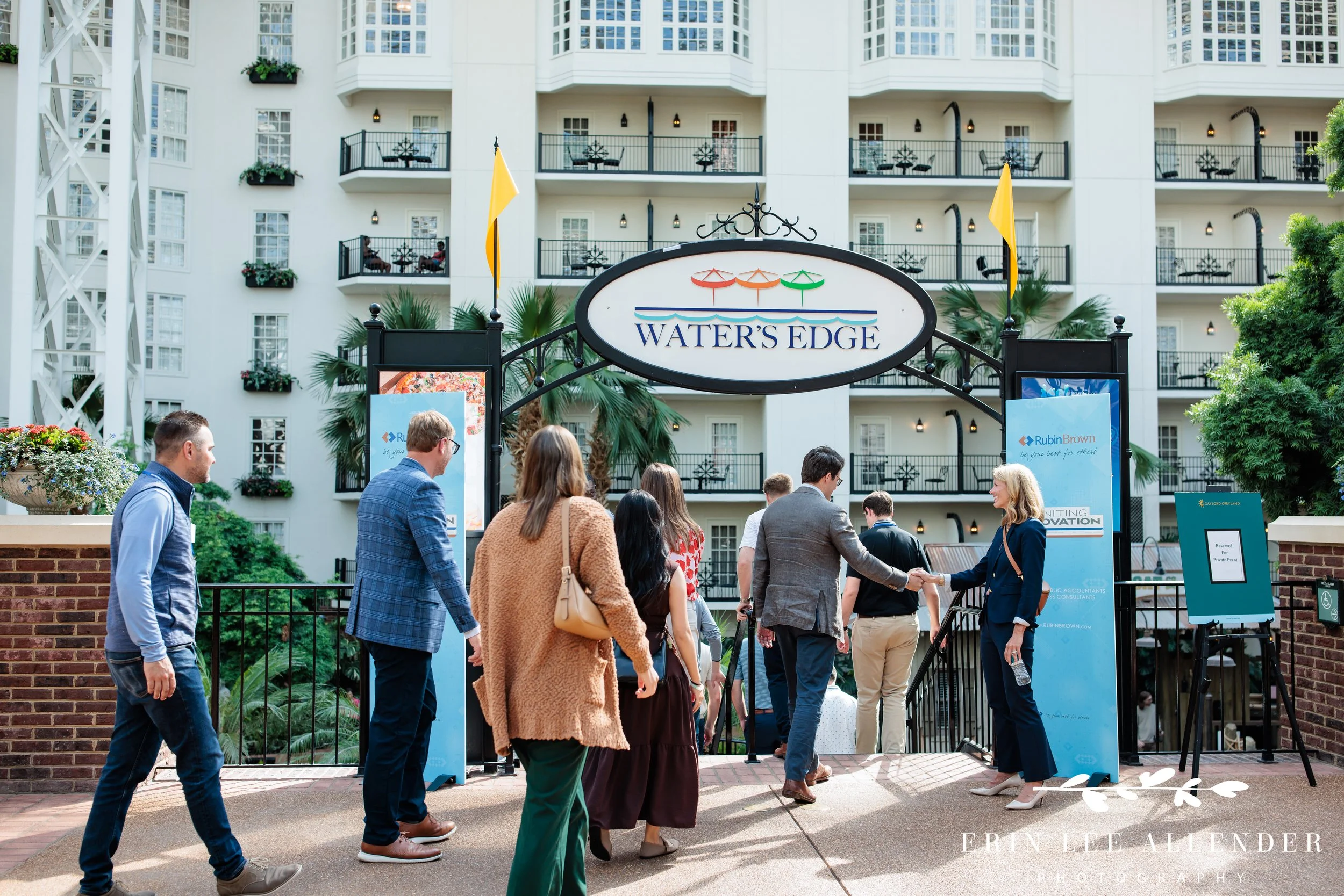 Nashville corporate event photographer capturing RubinBrown's CEO greeting guests and shaking hands at Water's Edge on Delta Island at Gaylord Opryland Resort