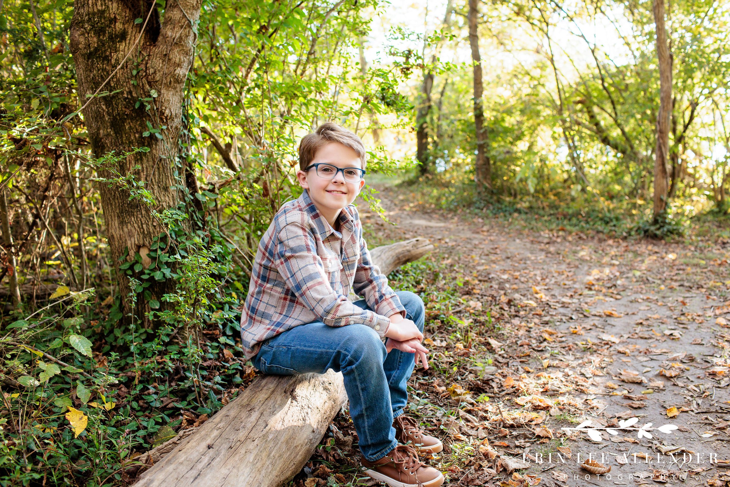 Nashville family portrait — young boy sitting on a log looking at the camera at Walton Ferry Arboretum