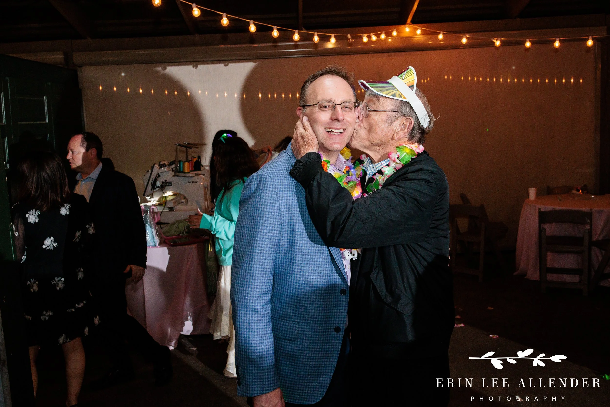 Nashville family photography — grandpa kissing his son on the cheek at Sari's bat mitzvah Loveless Barn