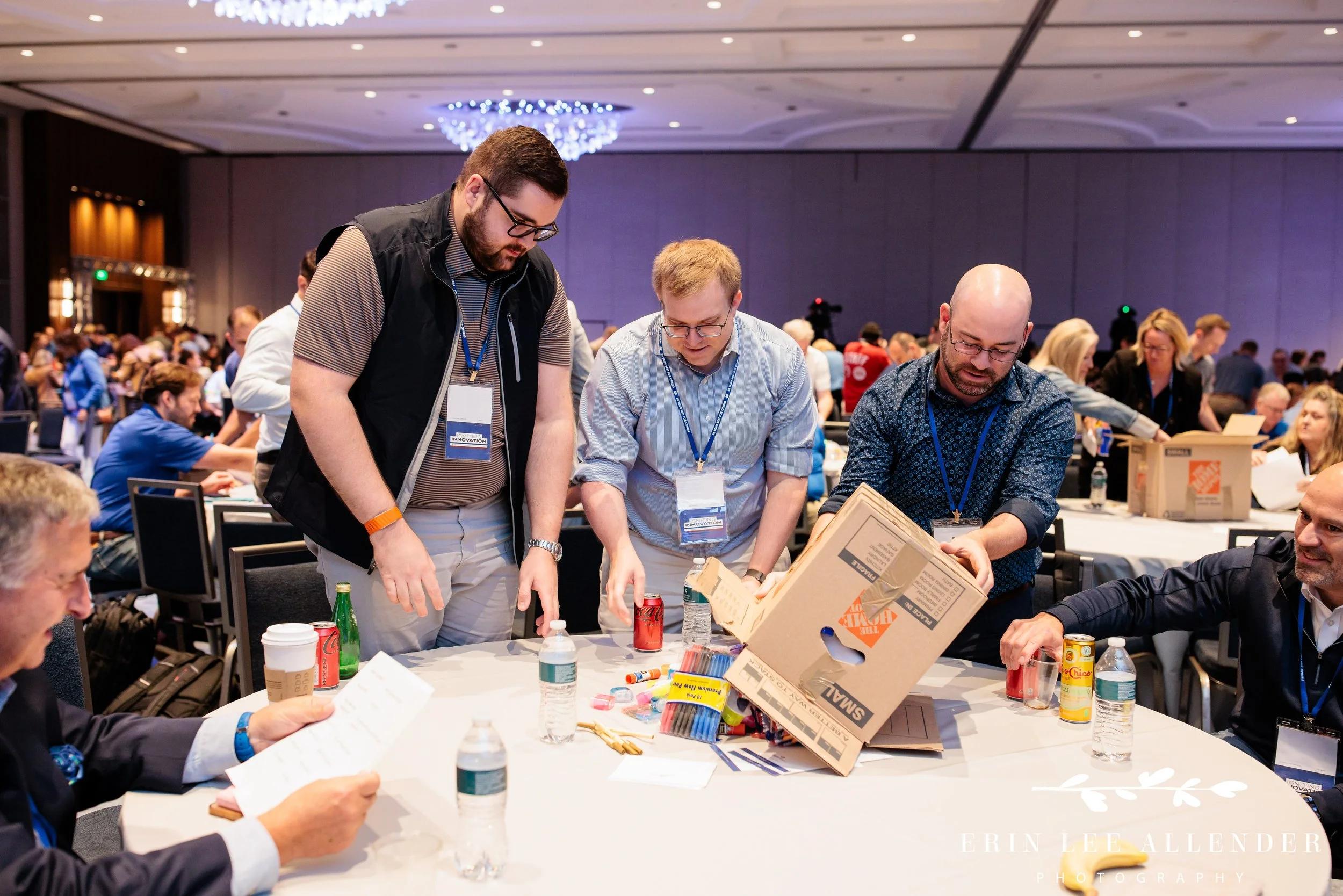 Nashville corporate event photographer capturing a group dumping out boxes of supplies during RubinBrown's Hands On service project at Gaylord Opryland Resort