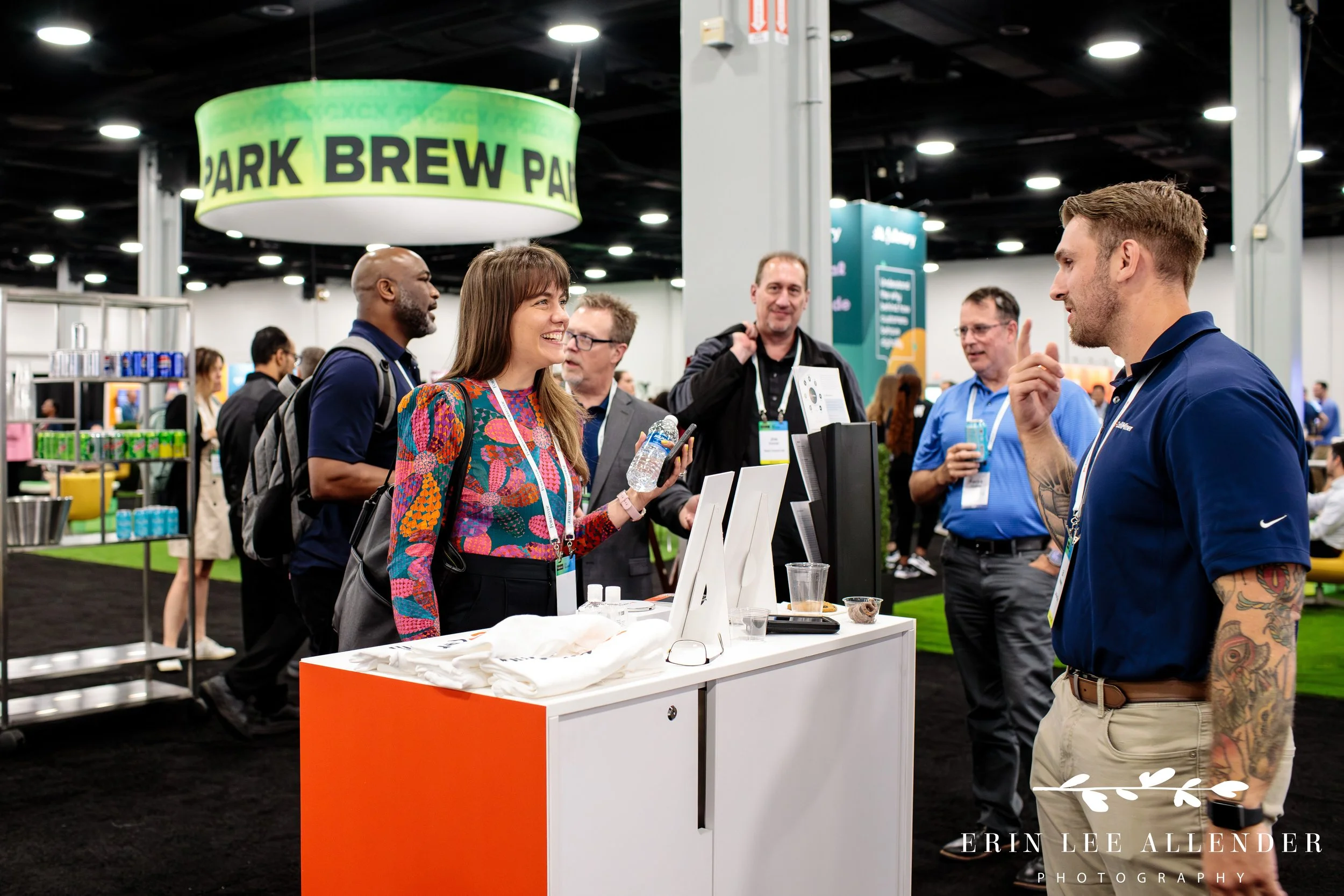 Attendees networking at vendor booths in the expo hall during corporate CX conference at Gaylord Opryland Hotel