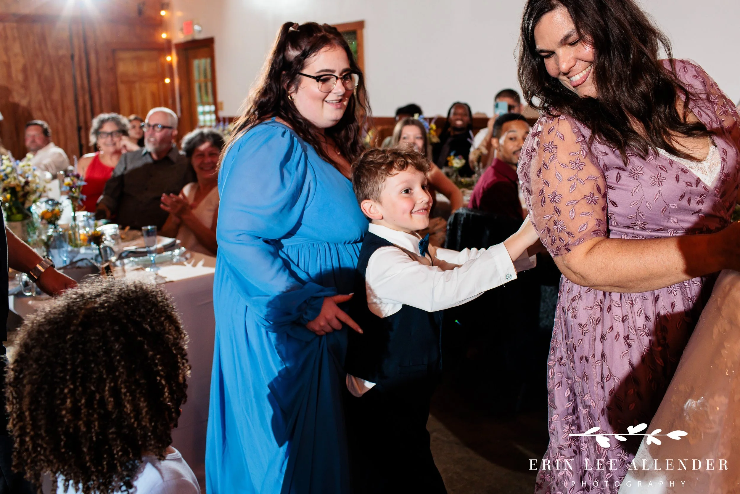 bride's son in conga line on wedding reception dance floor.