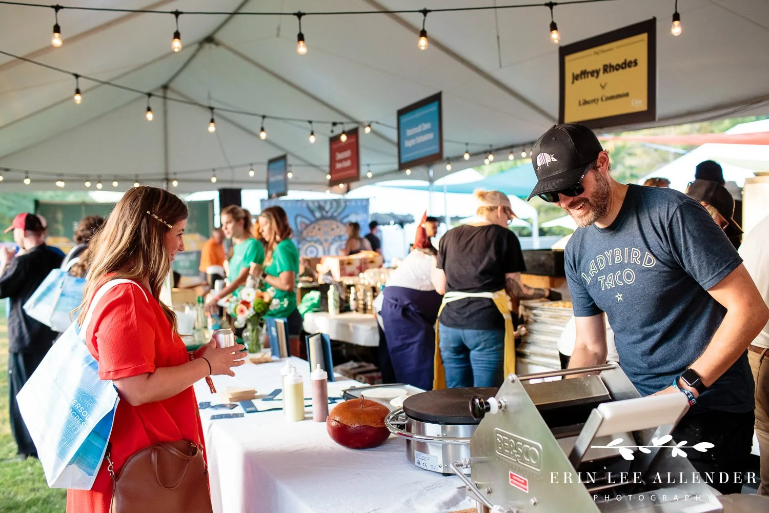 Chef plating and handing out food samples to guests at the Music City Food and Wine Festival Nashville