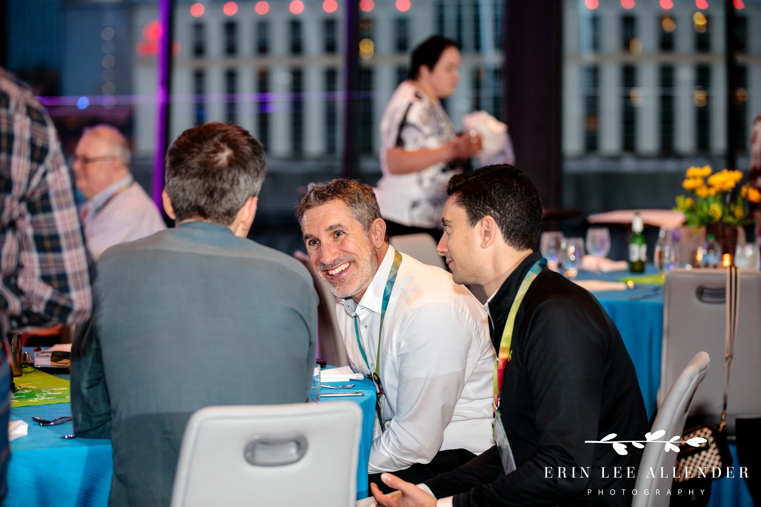 Conference attendees engaged in small group networking at Country Music Hall of Fame opening night party