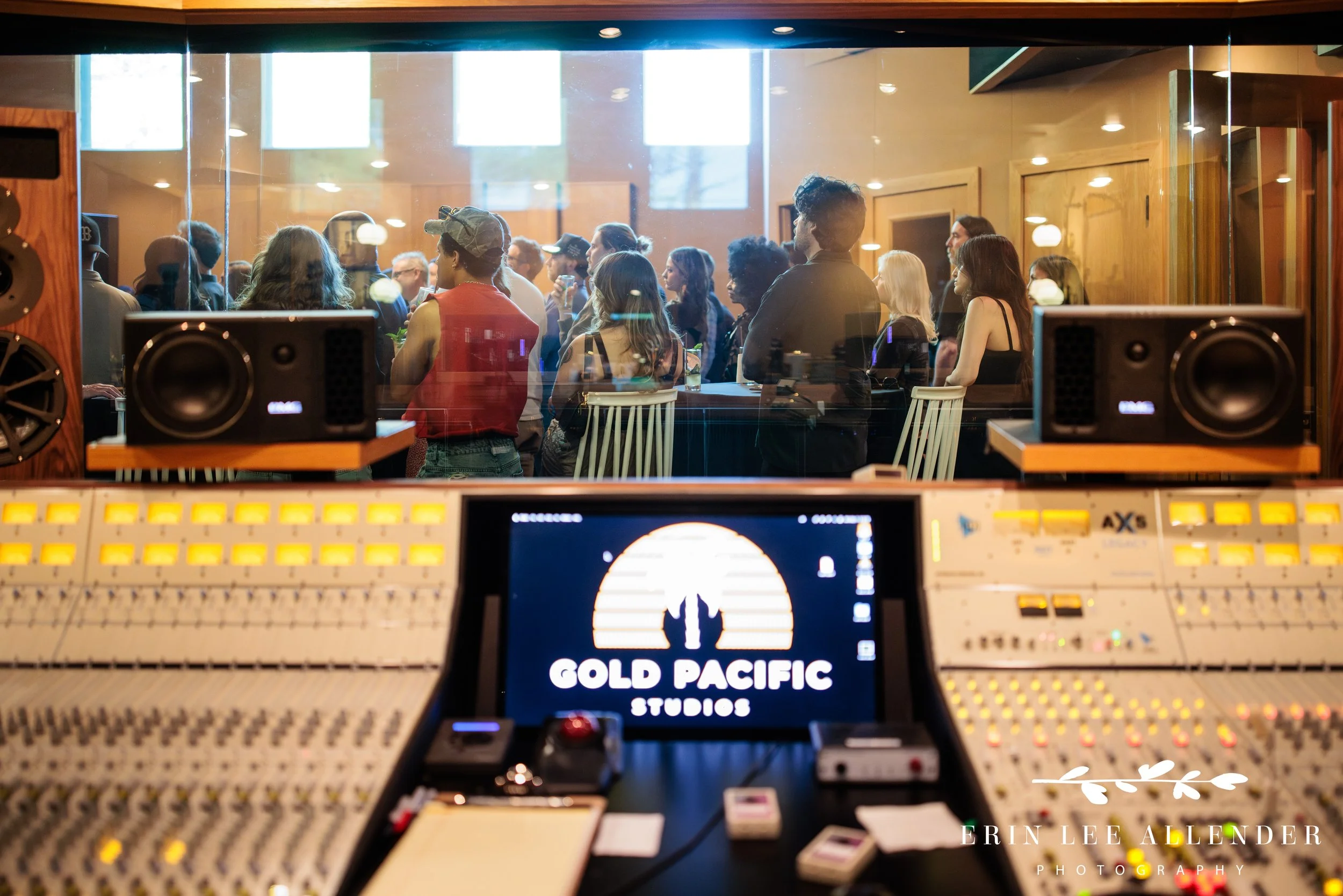 Guests watch a presentation from the recording booth console at Gold Pacific Studios during the Save the Music fundraiser in Nashville