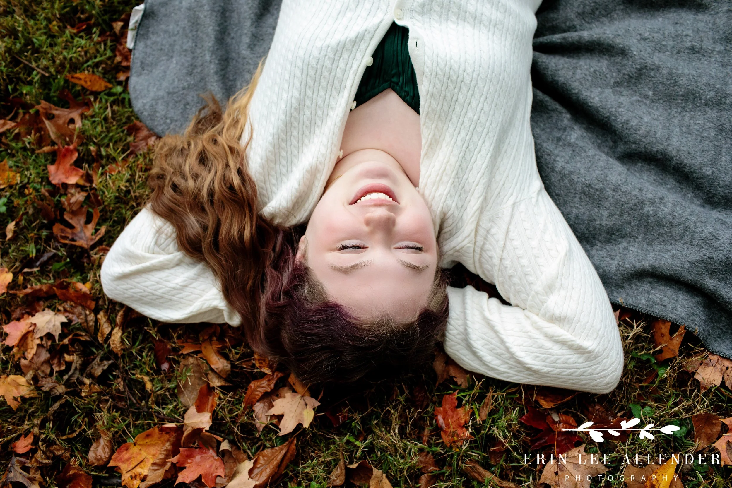 Daughter laying in fall leaves during a Nashville family photography session at Ellington Agricultural Center