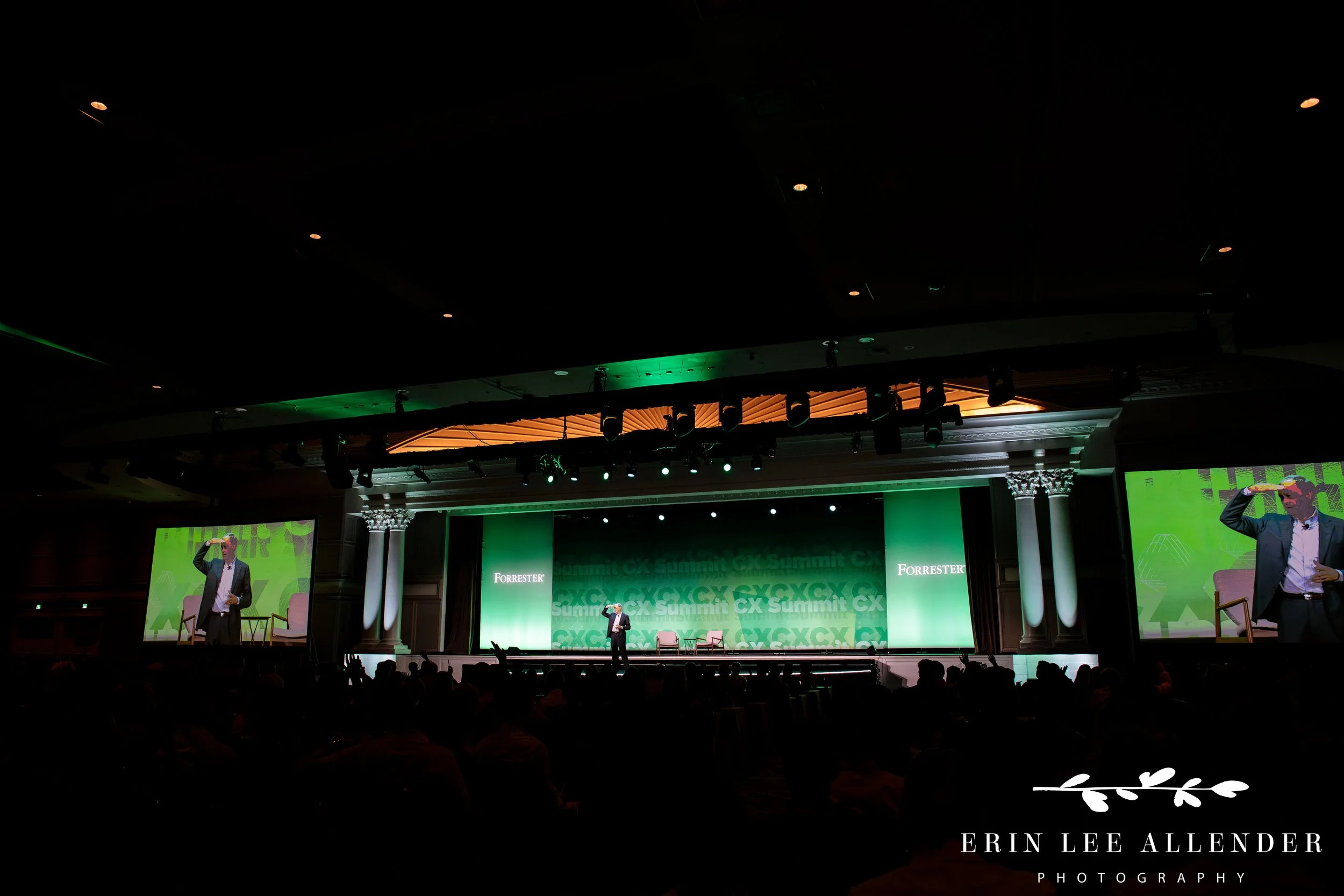 wide view of conference room with large audience and presentation screens at opryland hotel