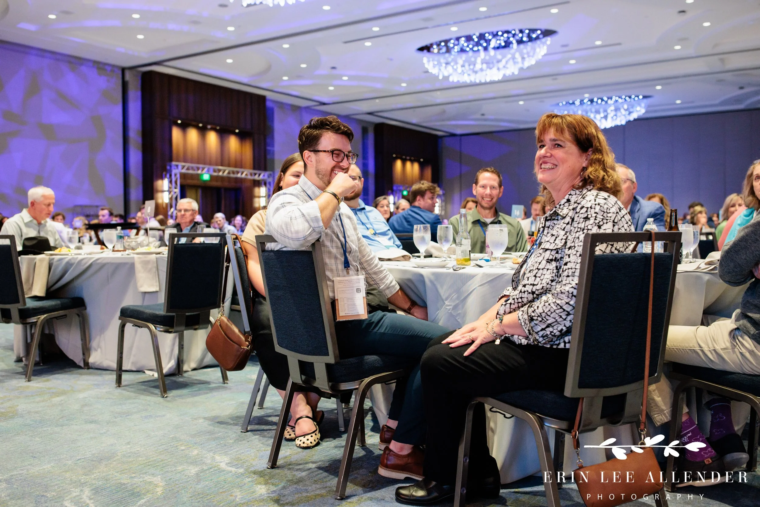 Nashville corporate event photographer capturing a recipient's shocked reaction in their seat during RubinBrown's awards dinner at Opryland