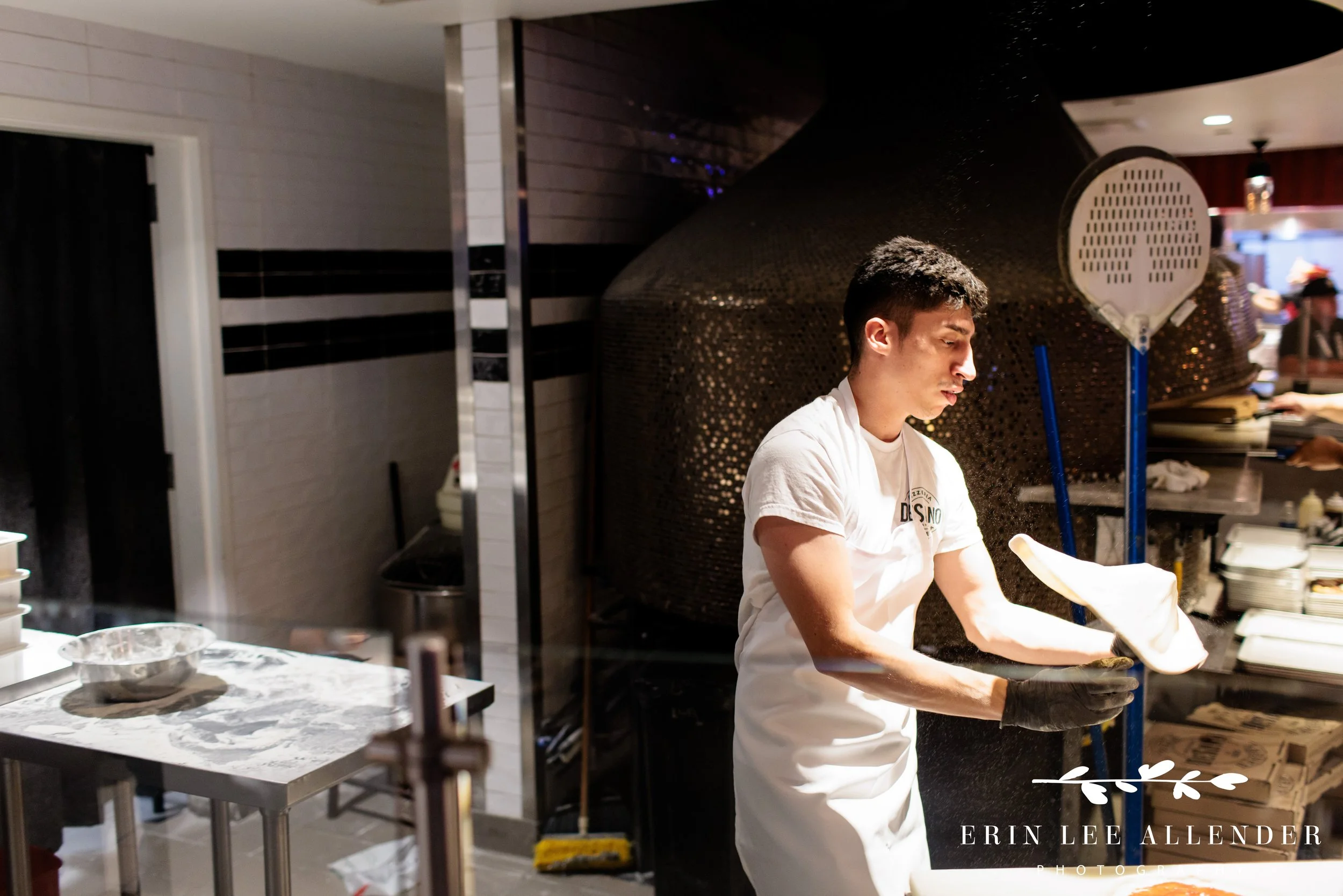 Chef preparing pizza for guests at Assembly Food Hall during a corporate event