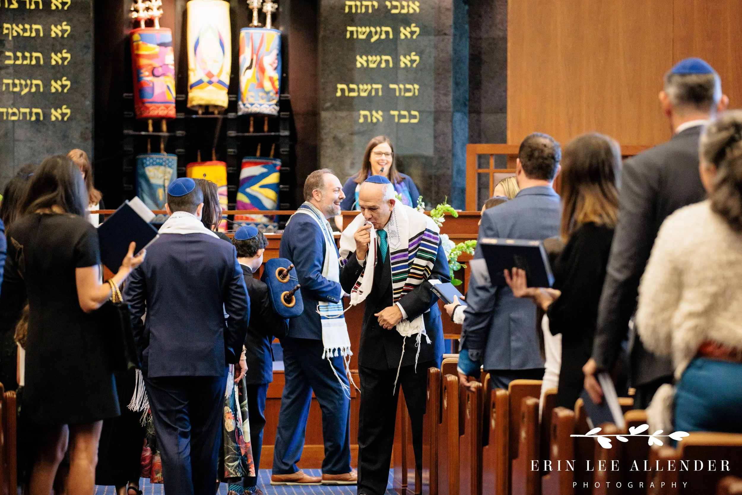 Grandfather kissing his tallit after touching Torah at The Temple