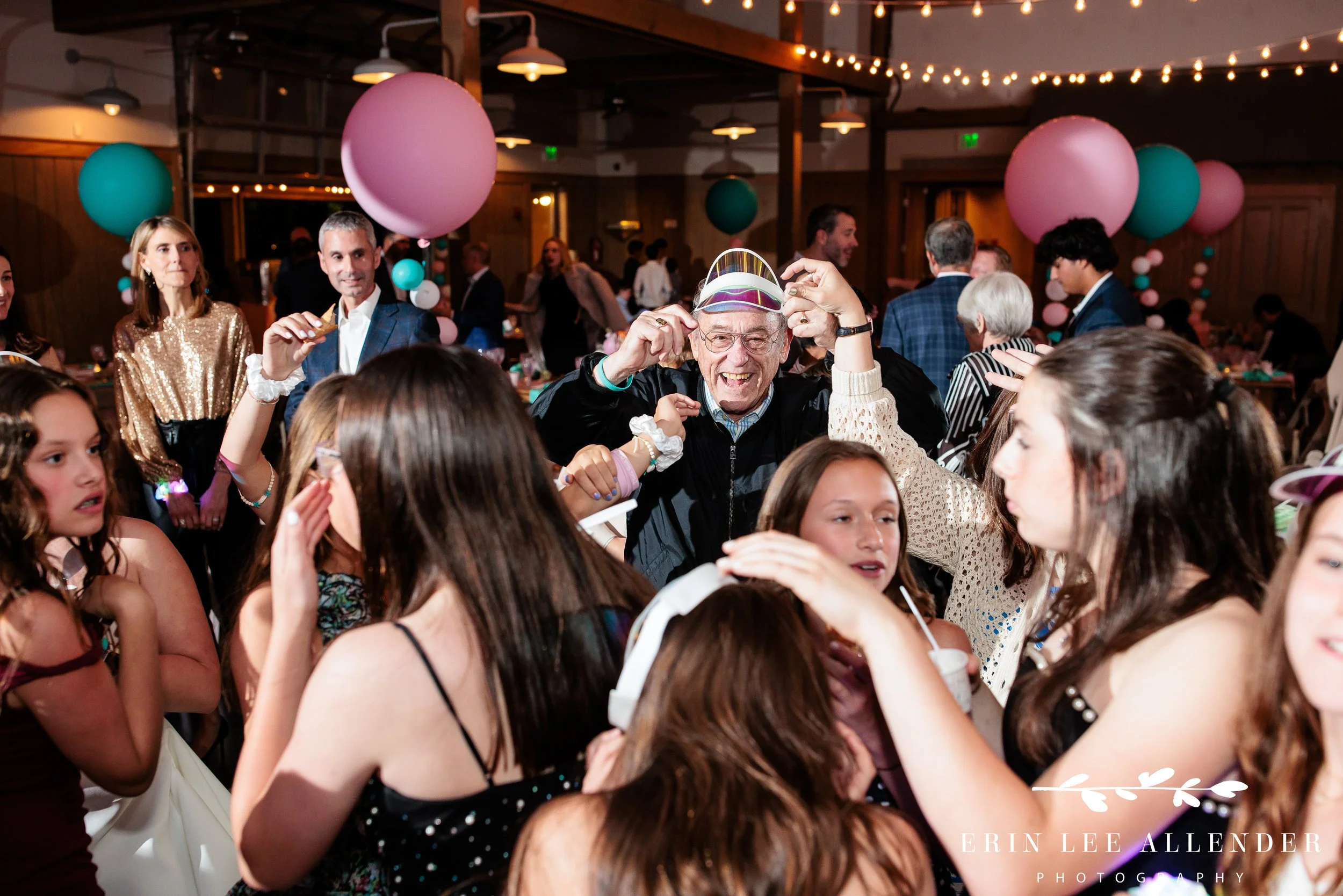 Nashville mitzvah photographer — grandpa dancing in visor on the dance floor at Loveless Barn Nashville