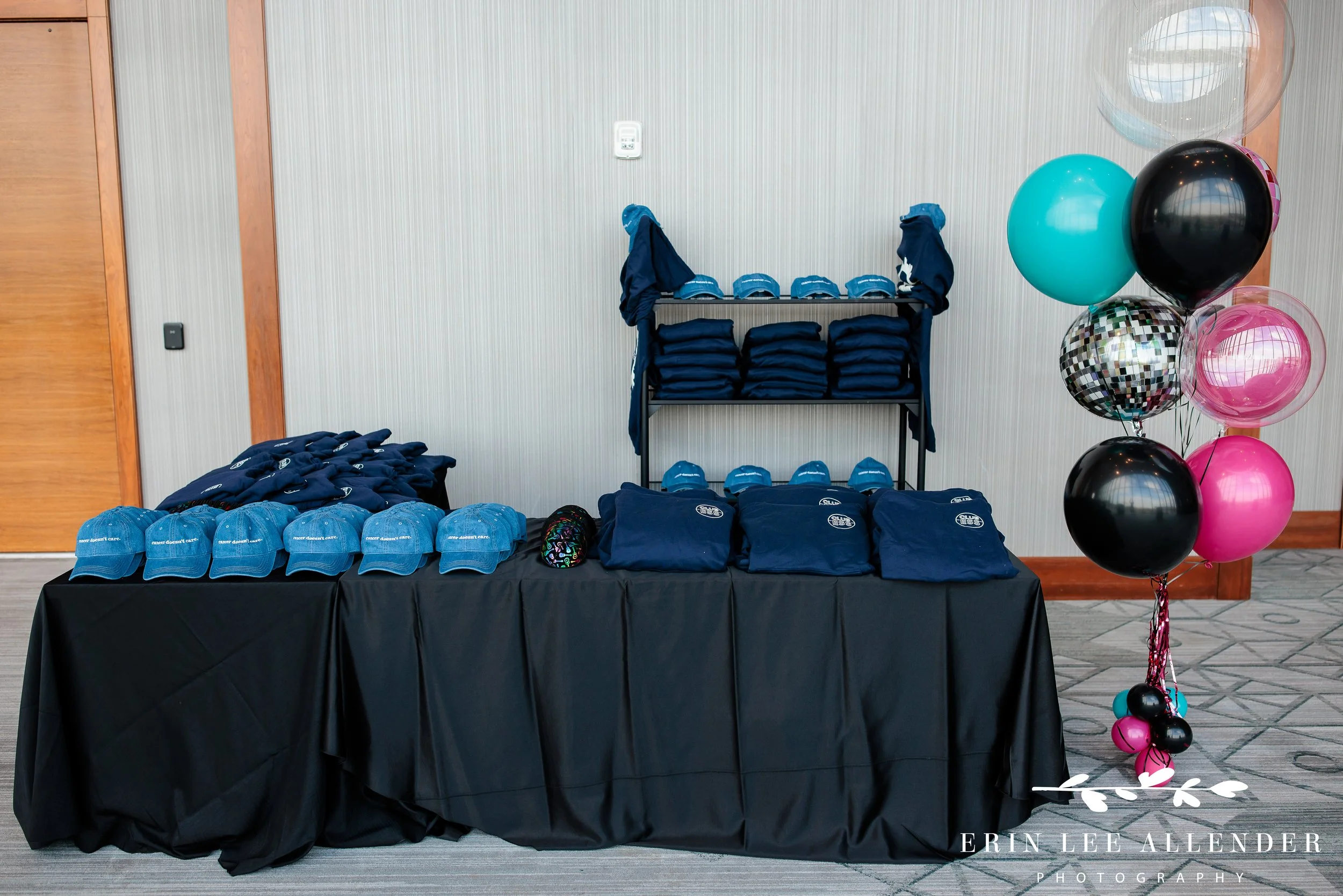 Custom merch display styled like concert booth