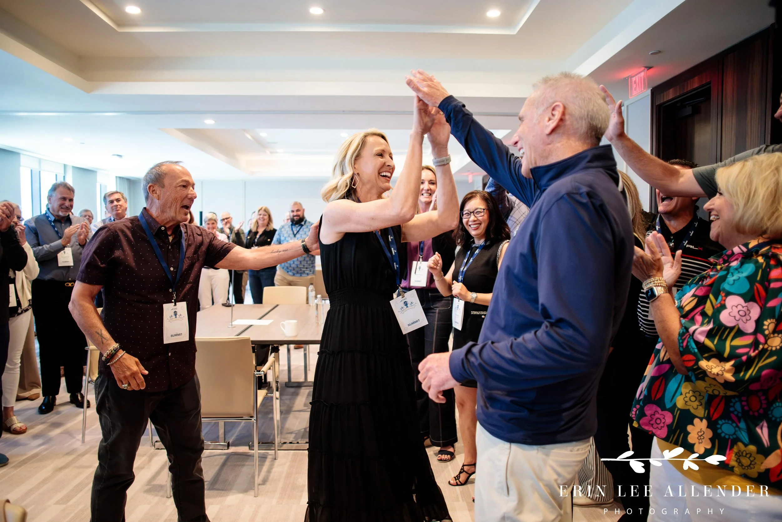 Nashville corporate event photography — attendees playing rock paper scissors during CBIZ Nashville Summit team building at The Conrad