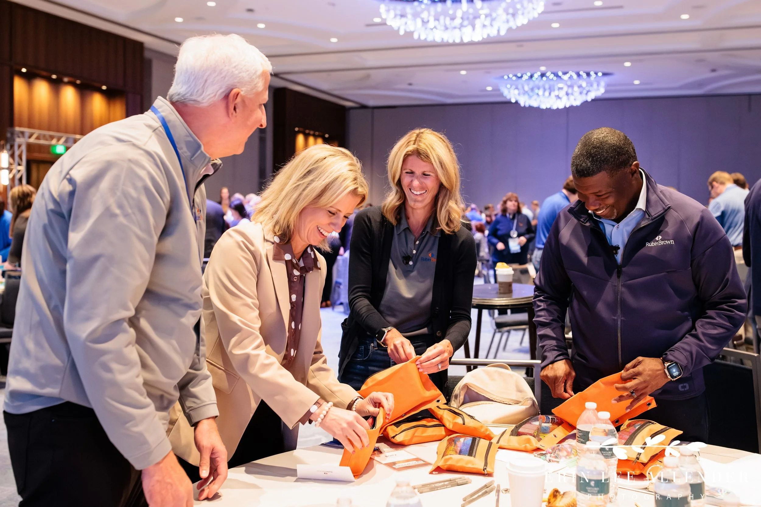 Nashville conference photographer capturing RubinBrown's managing partners filling pencil bags during their Hands On service project at Gaylord Opryland Resort