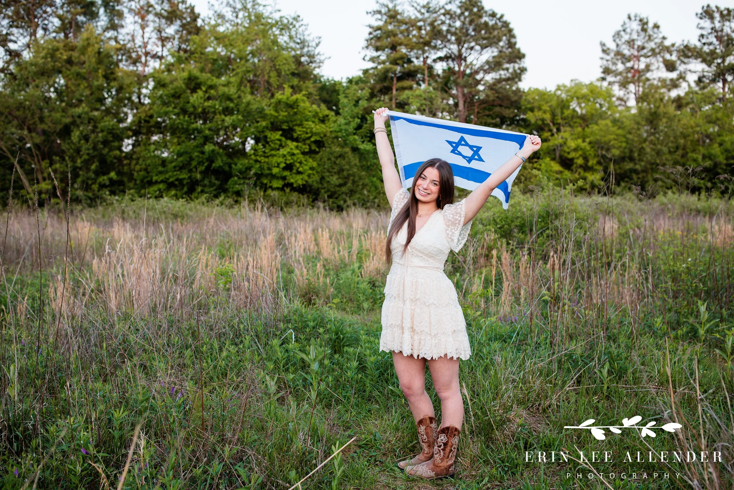 Nashville senior portraits — high school senior holding Israeli flag in an open field, meaningful senior session props