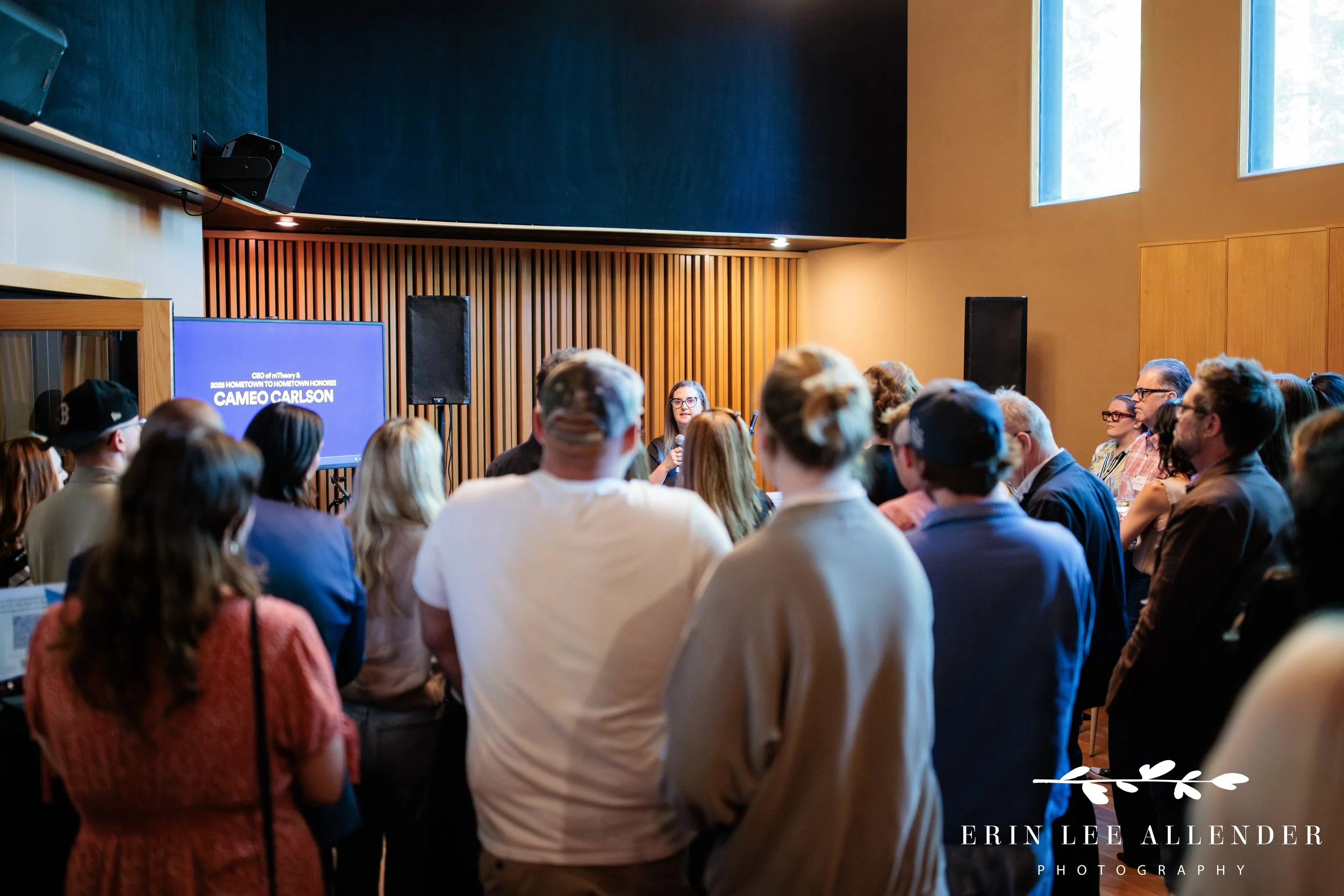 Wide room shot of the Save the Music Foundation fundraiser at Gold Pacific Studios with a speaker addressing the crowd