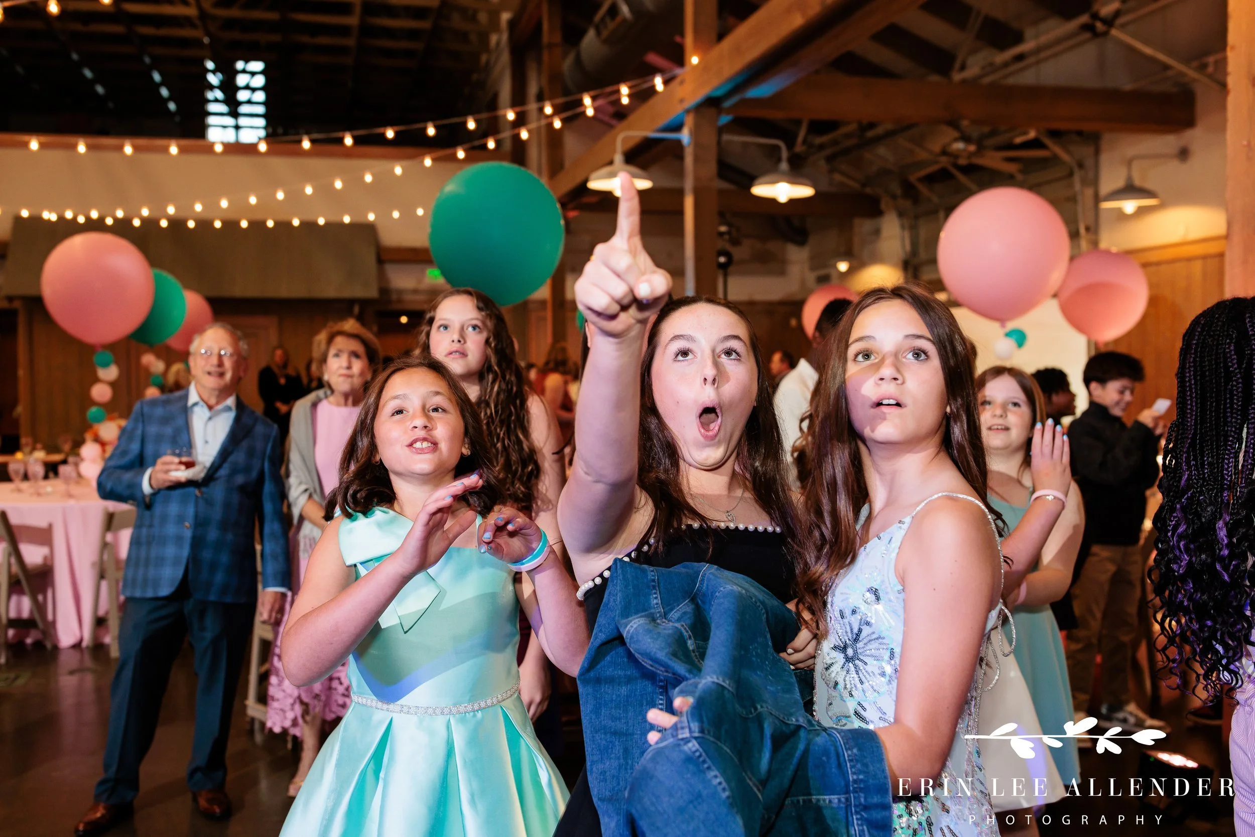 Nashville mitzvah photographer — kids laughing at slideshow during Sari's bat mitzvah at Loveless Barn