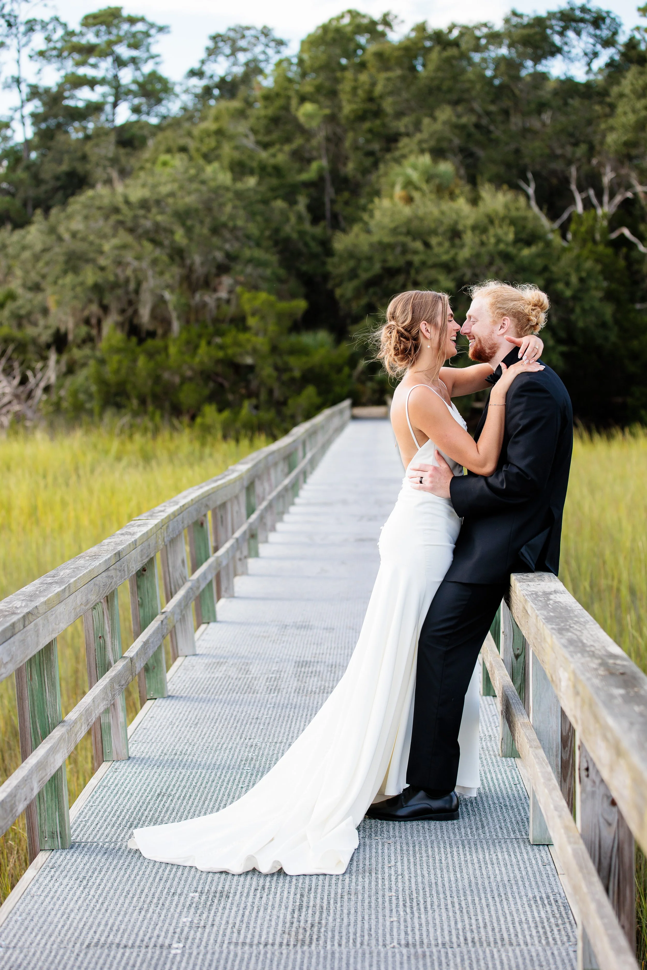 couple cuddled on dock at wedding in Darien GA
