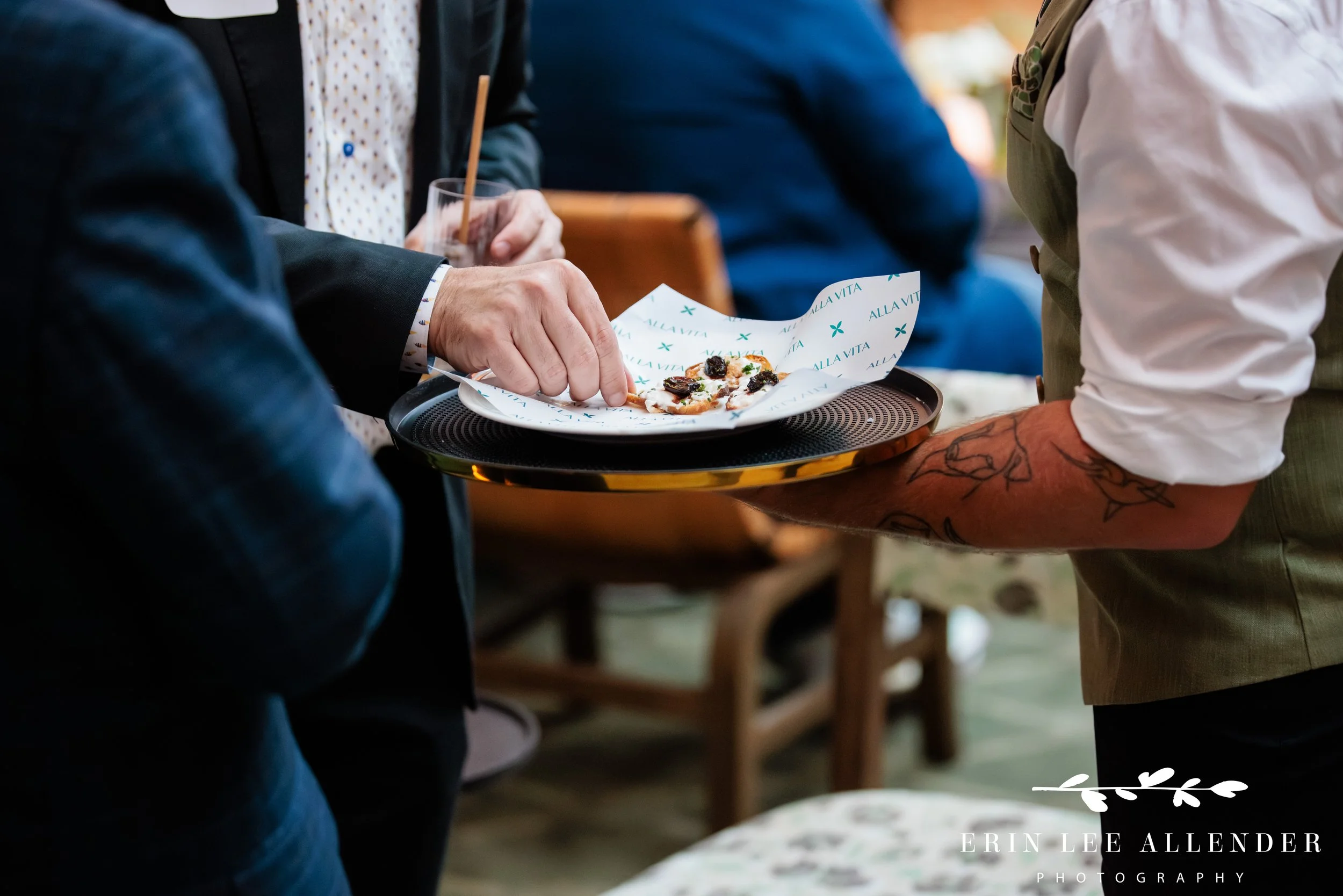 Close-up of a hand reaching for a passed appetizer — Nashville corporate event photography at Middleman
