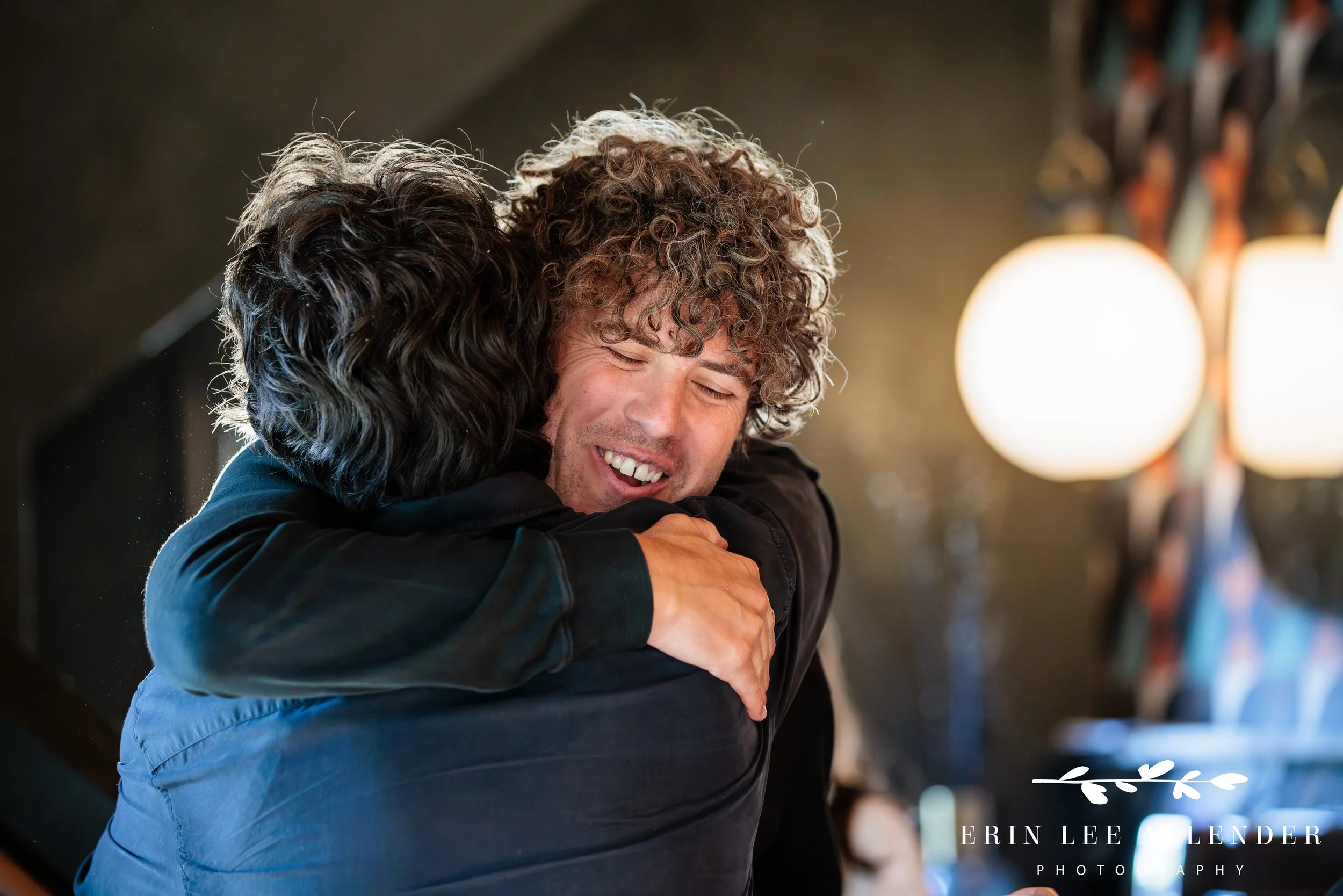 Nashville corporate event photography — two attendees embracing at the Save the Music Foundation fundraiser at Gold Pacific Studios