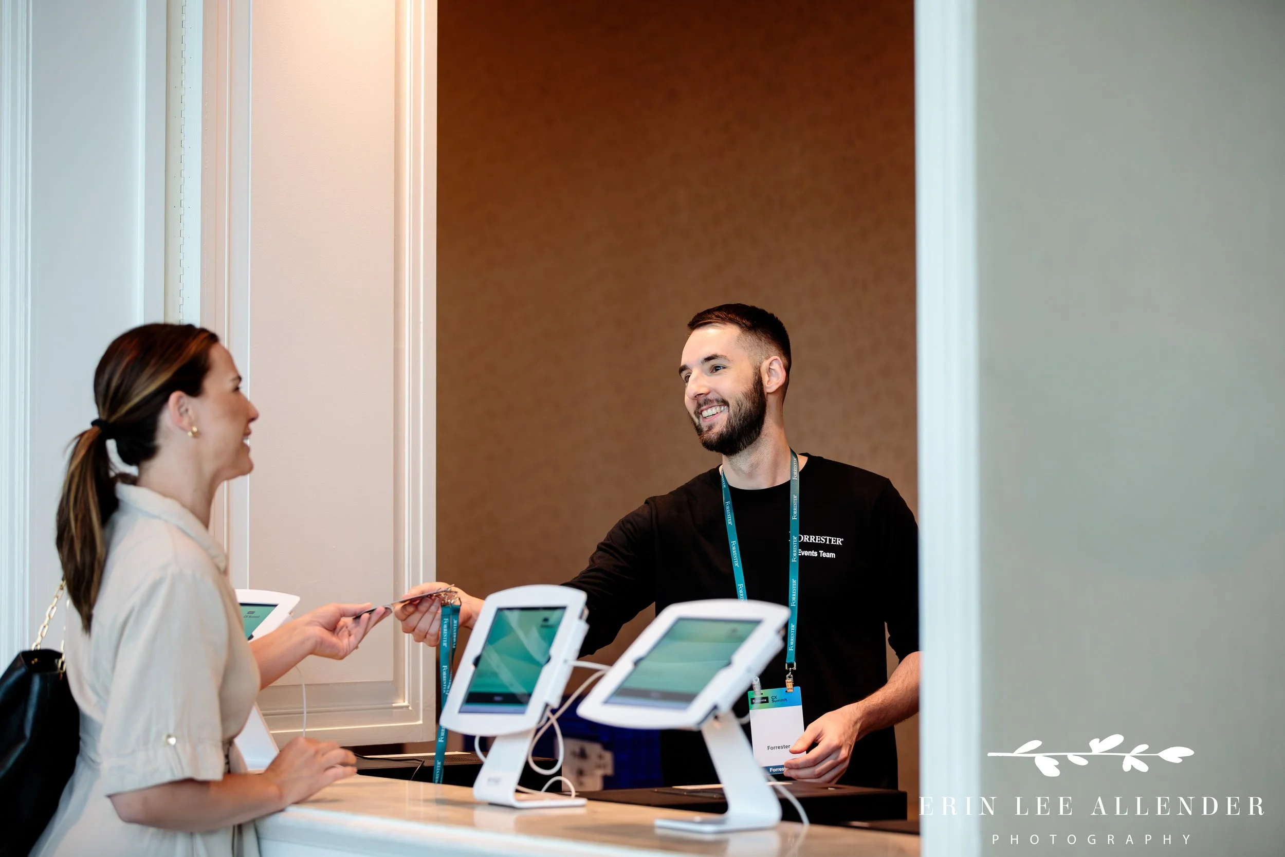 Event staff handing guests their badges at CX corporate conference registration Gaylord Opryland Hotel