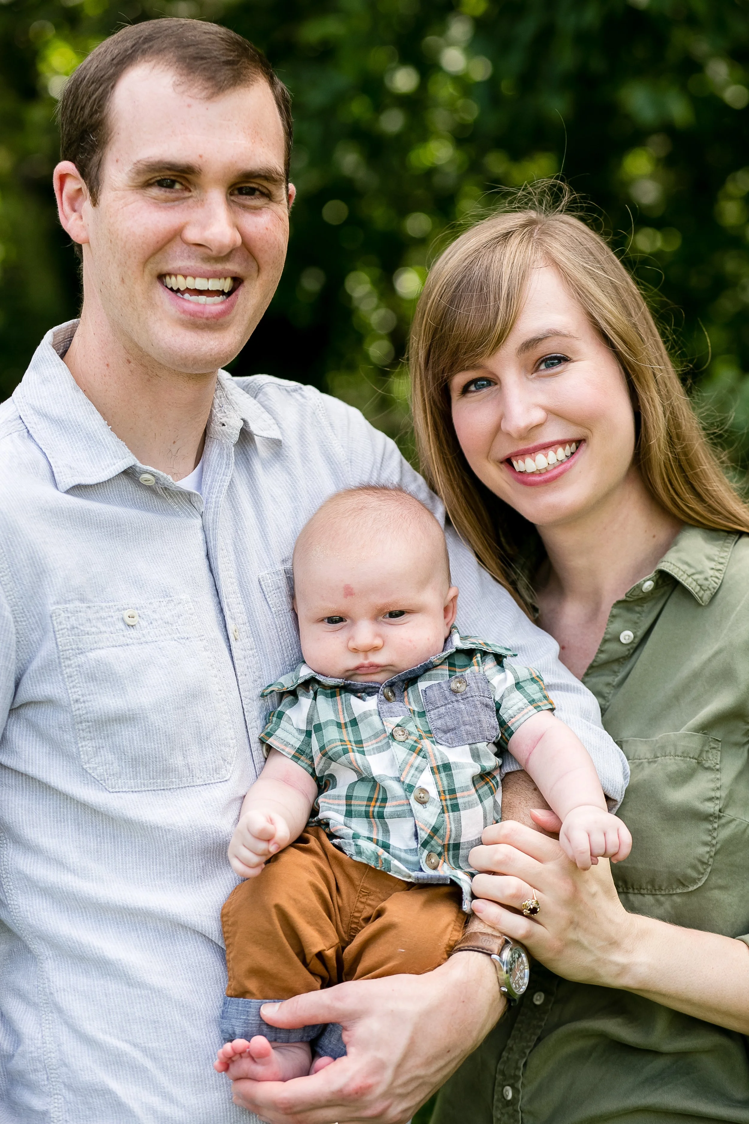 Nashville family photography — mom and dad holding their one-month-old son at their first family session with Erin Lee Allender Photography in 2016