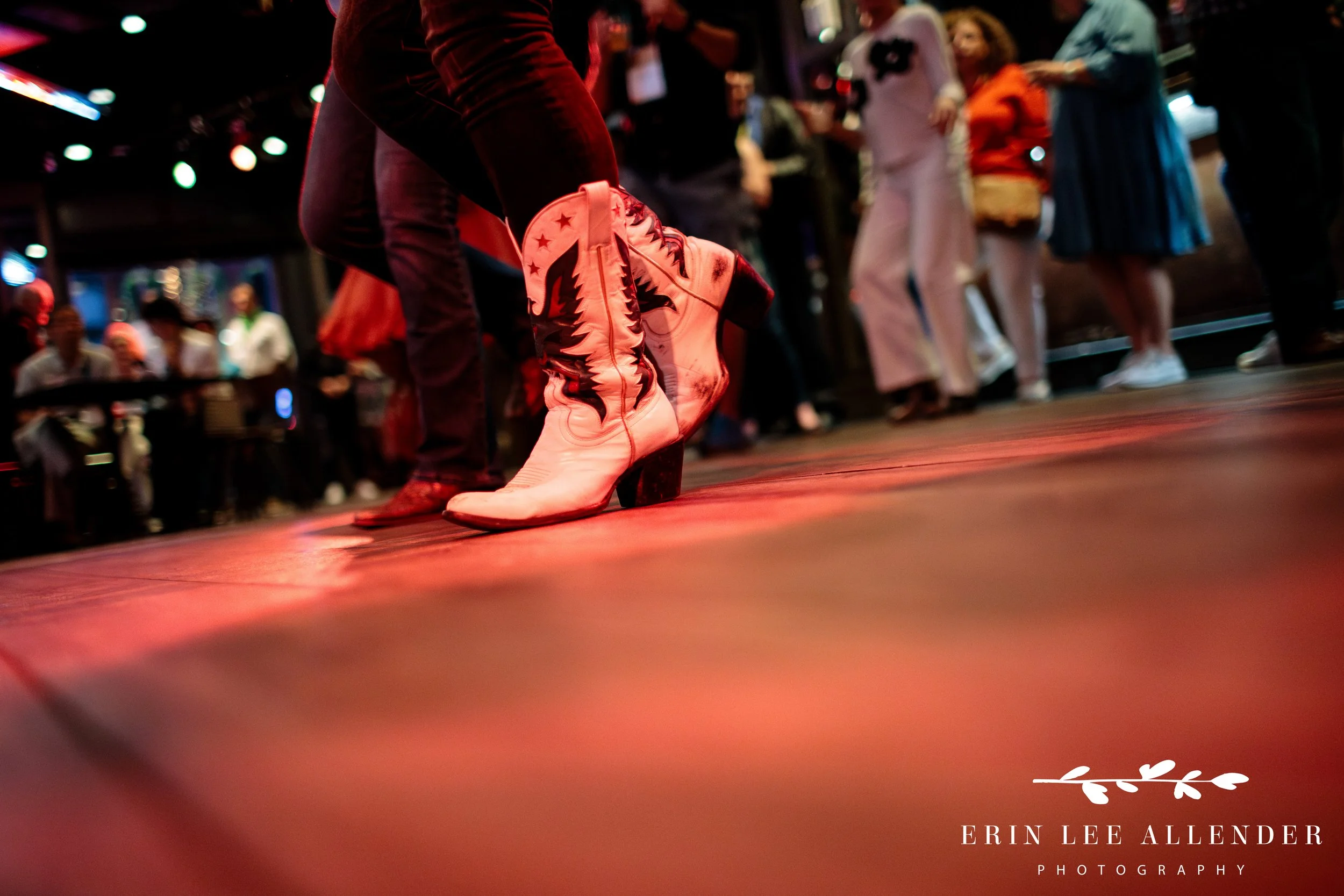 Close-up of cowboy boots on the dance floor during corporate conference closing night at Ole Red Downtown Nashville