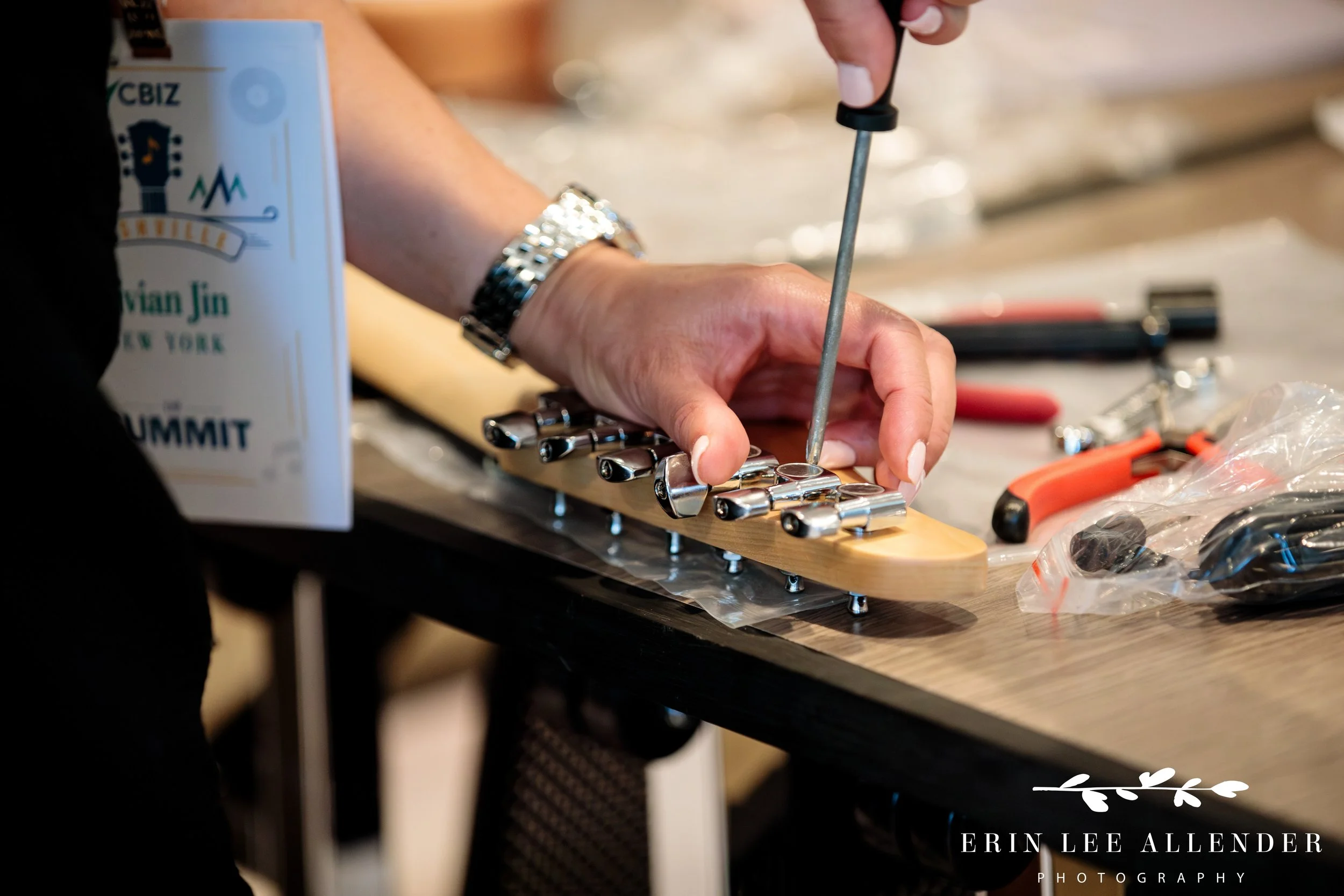 Nashville corporate event photographer — close-up of guitar strings being added during CBIZ Nashville Summit Guitars for Vets build
