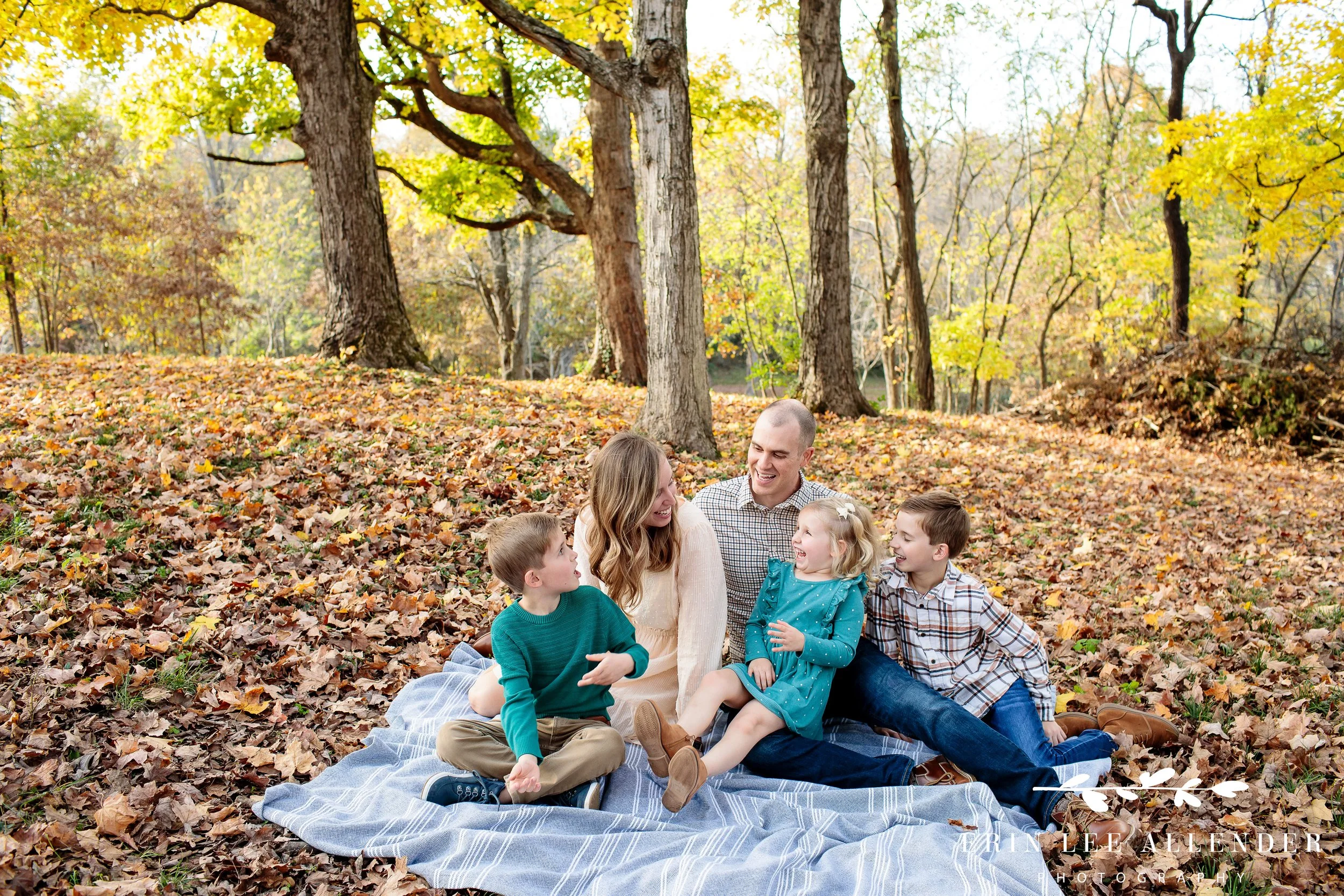 Nashville fall family session — family of five sitting together on a blanket at Ellington Agricultural Center