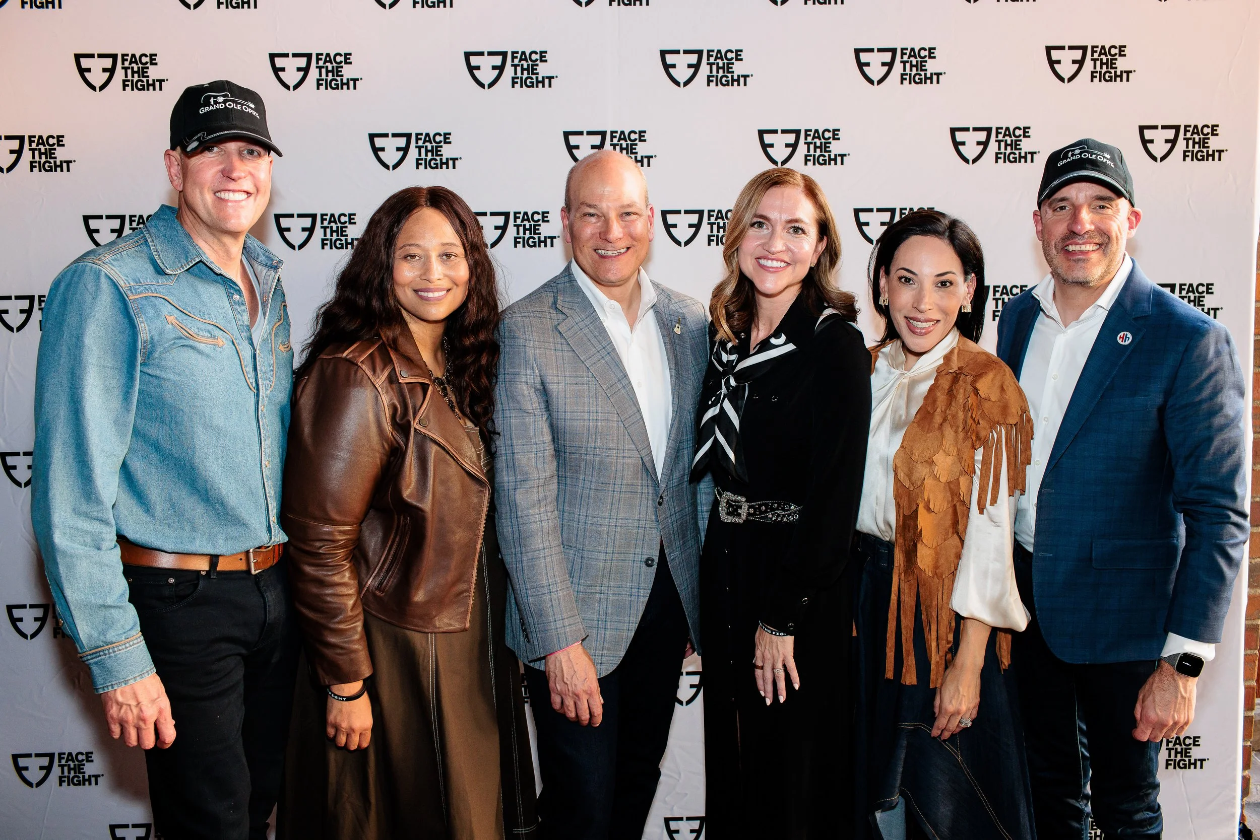 Photograph in front of Face the Fight Step and repeat at Grand Ole Opry in Nashville.