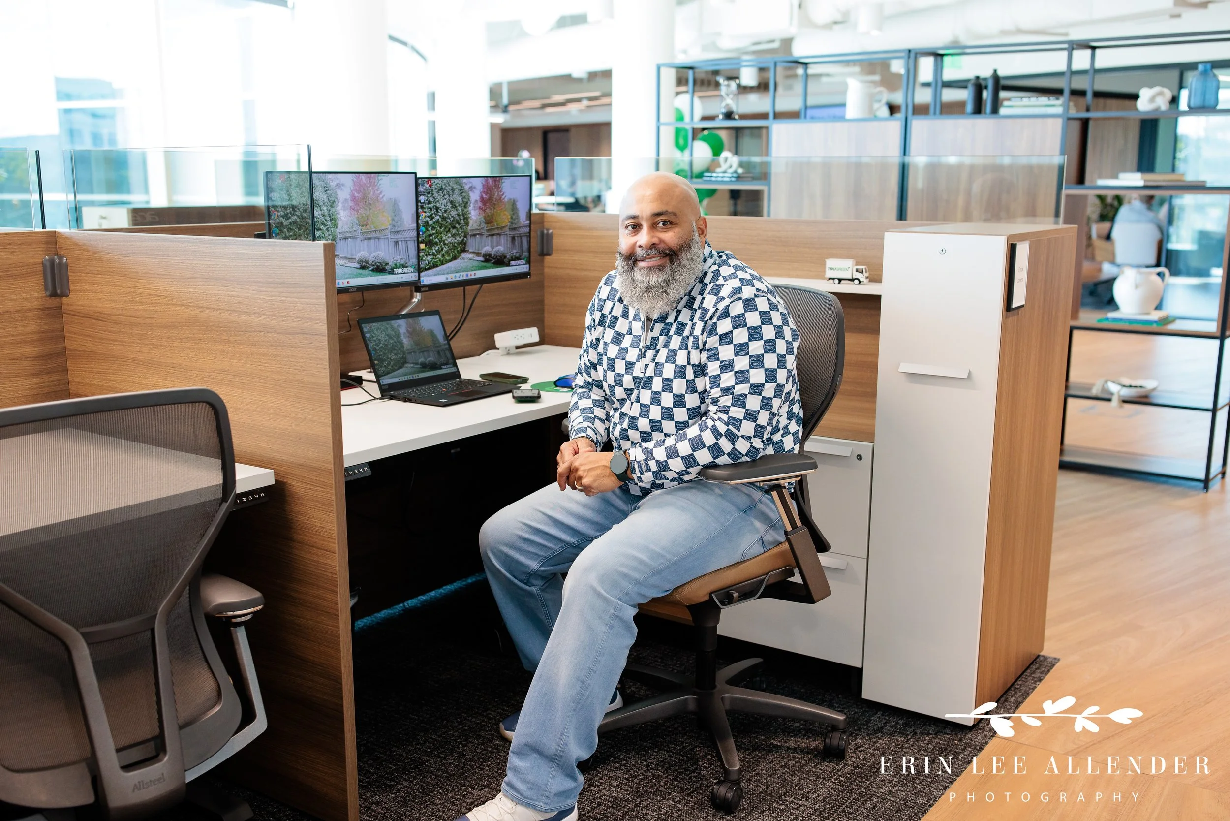 Nashville corporate event photographer — employee smiling at their cubicle during candid marketing session at TruGreen